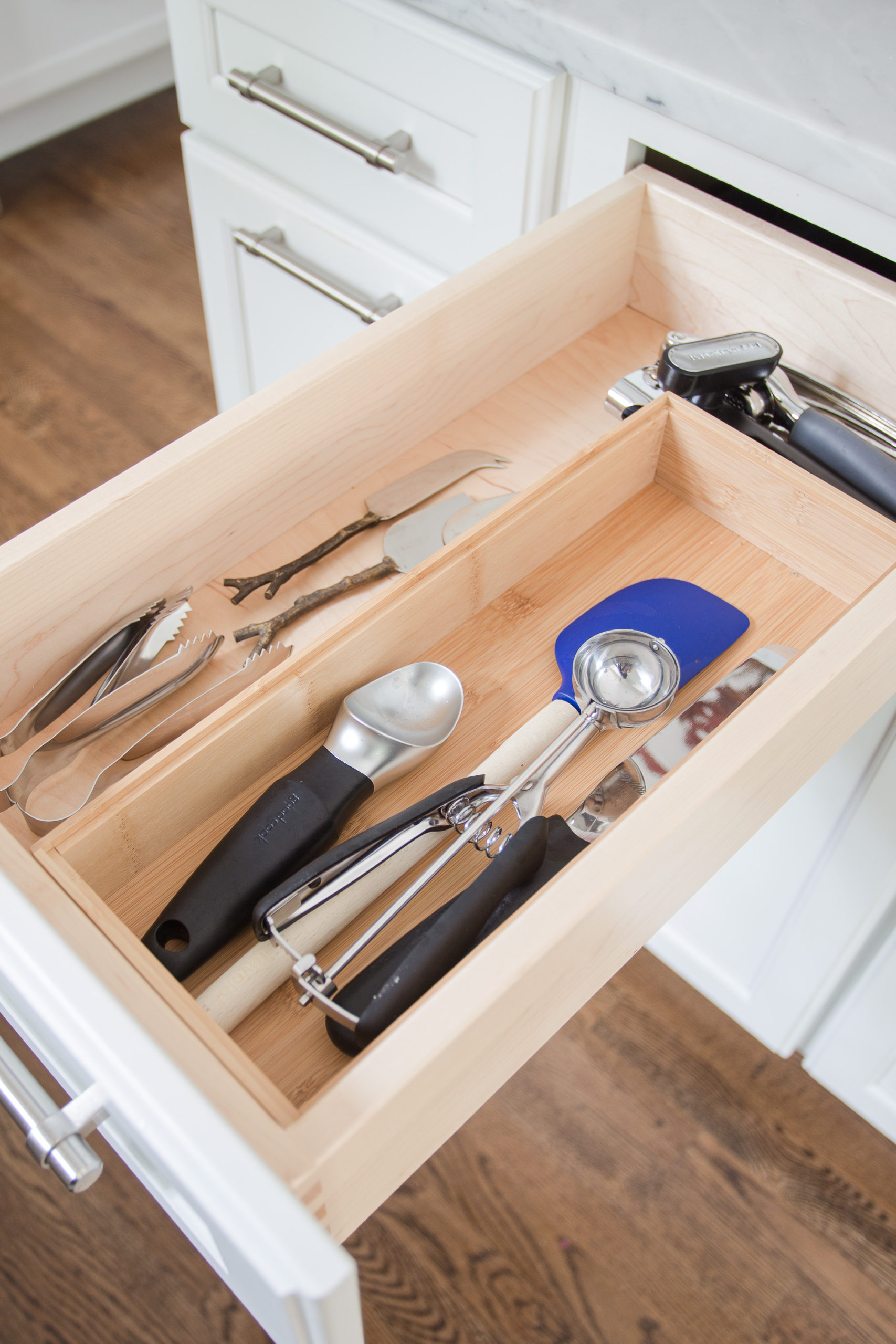 white kitchen drawer with kitchen utensils inside