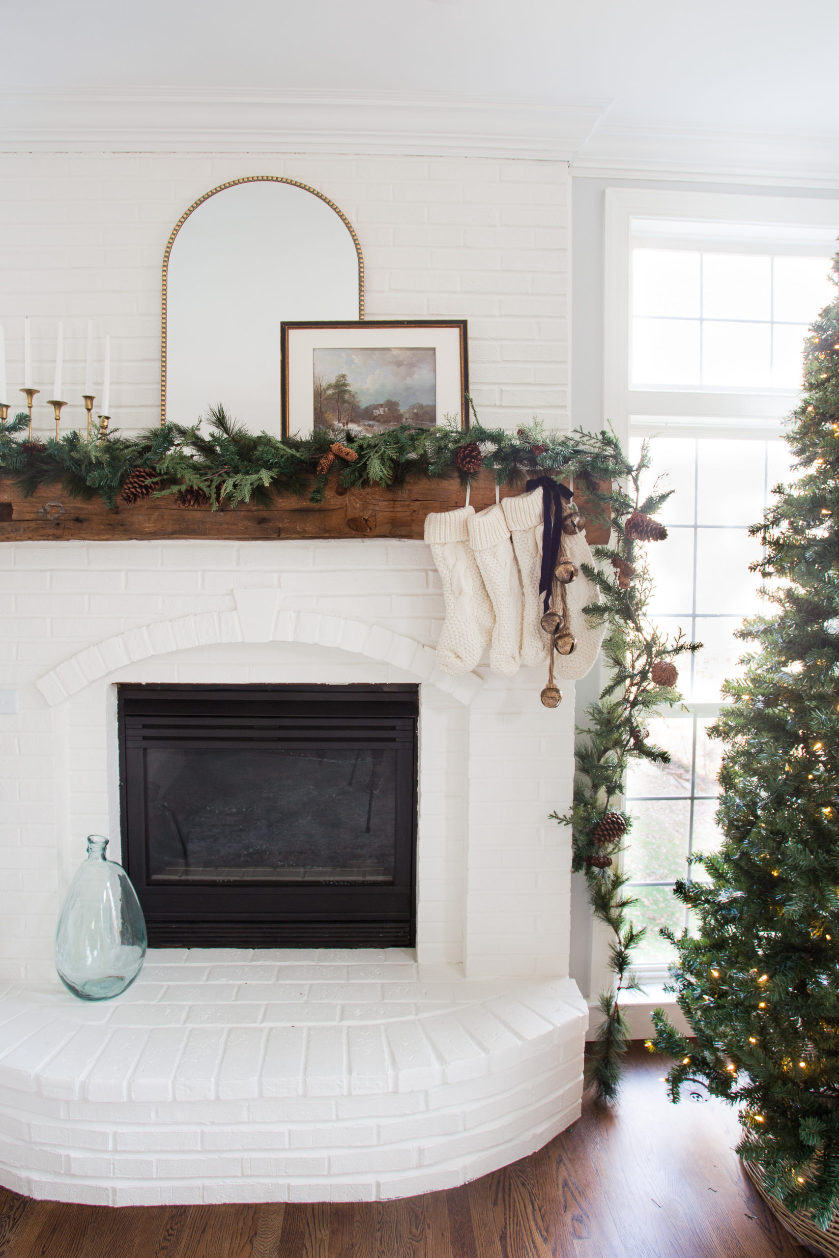 white fireplace with Christmas tree and garland