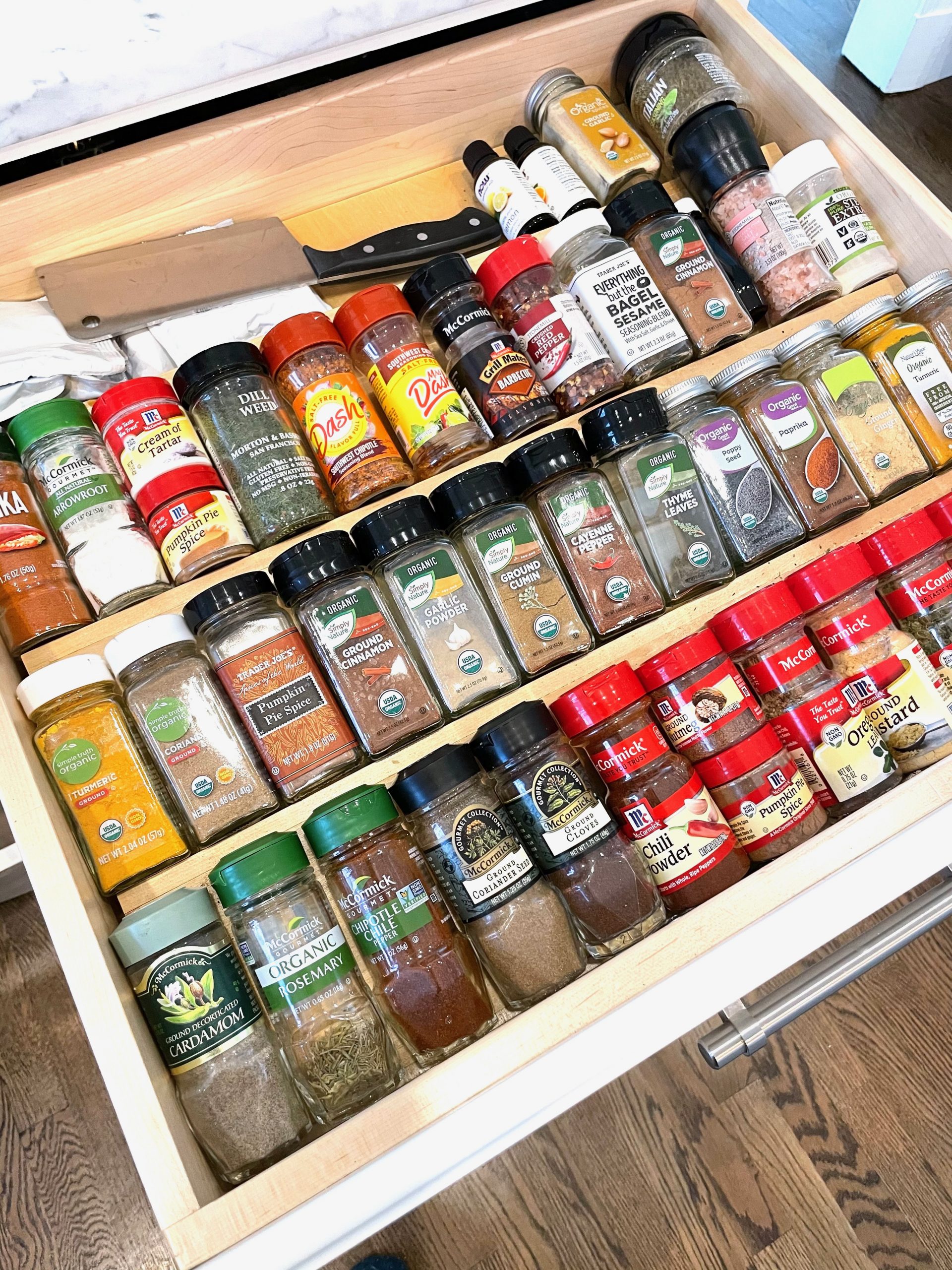 open spice drawer with random spices inside