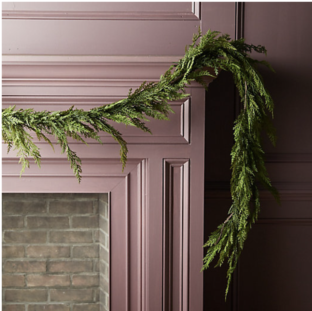 maroon fireplace with green christmas garland