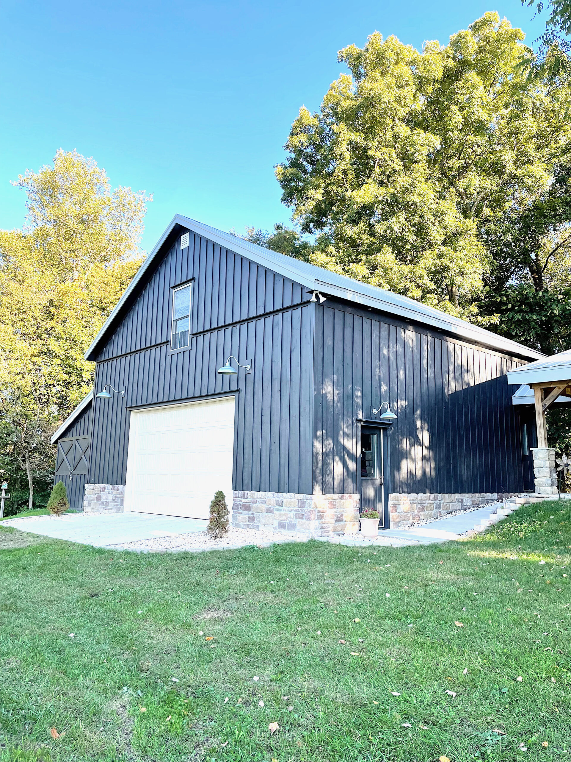 front of black barn with gray metal roof