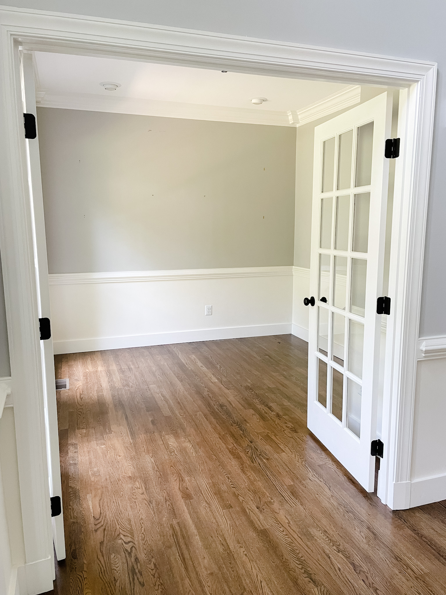 Empty room with wood floors painted with SW Light French Gray
