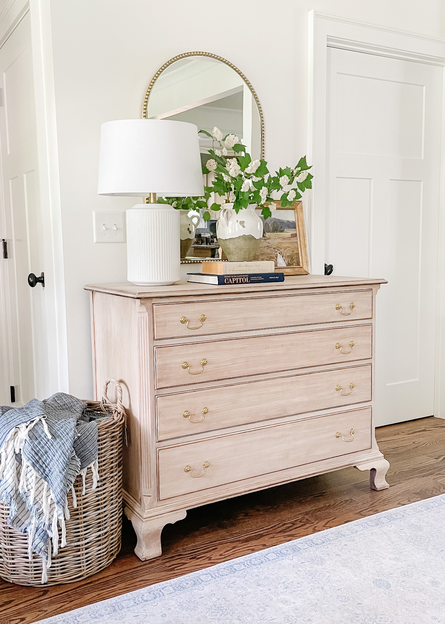 Bleached Wood dresser with mirror and vase of greenery