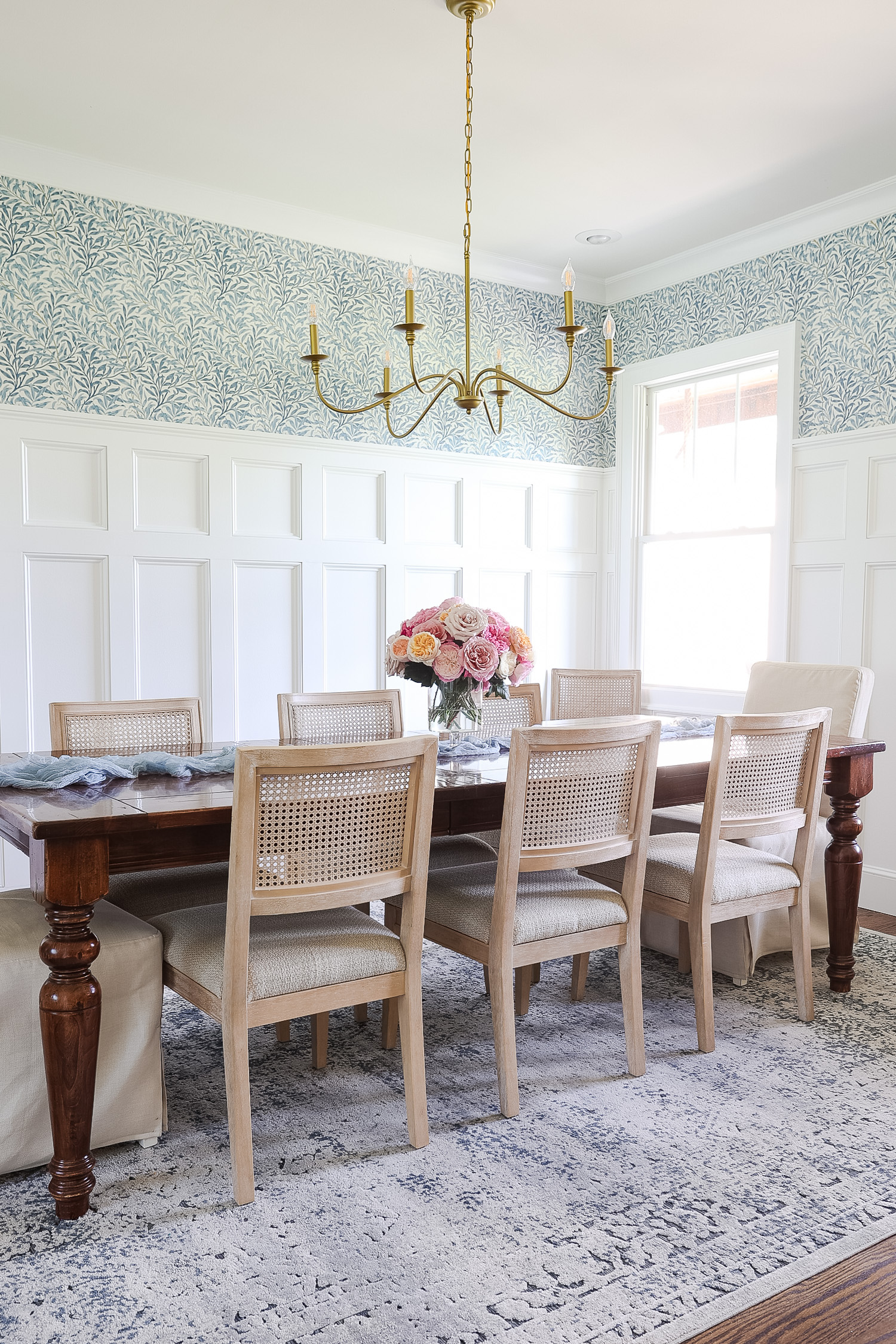 dining room with wallpaper and roses on the table