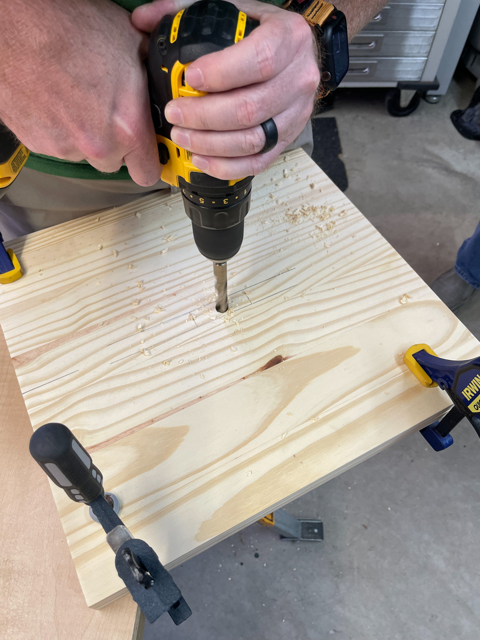 person drilling into wood for diy coffee table