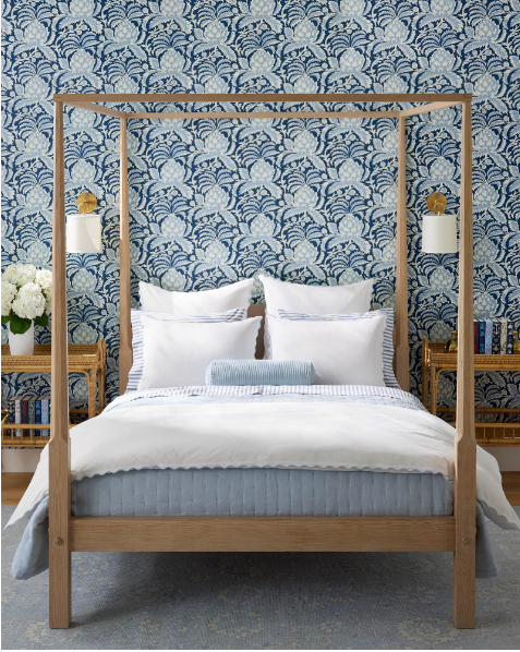 blue and white wallpaper in bedroom with post bed