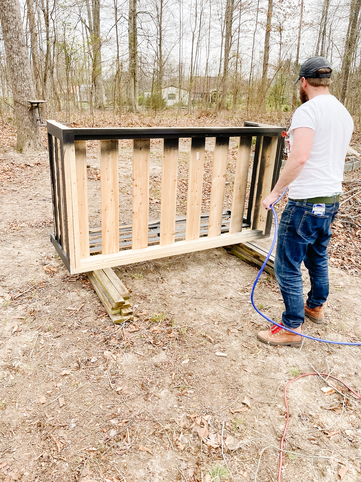 man painting porch swing bed