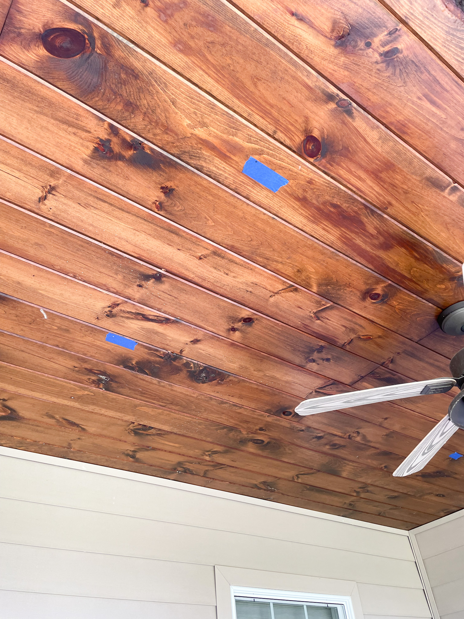 wood ceiling marked with blue tape