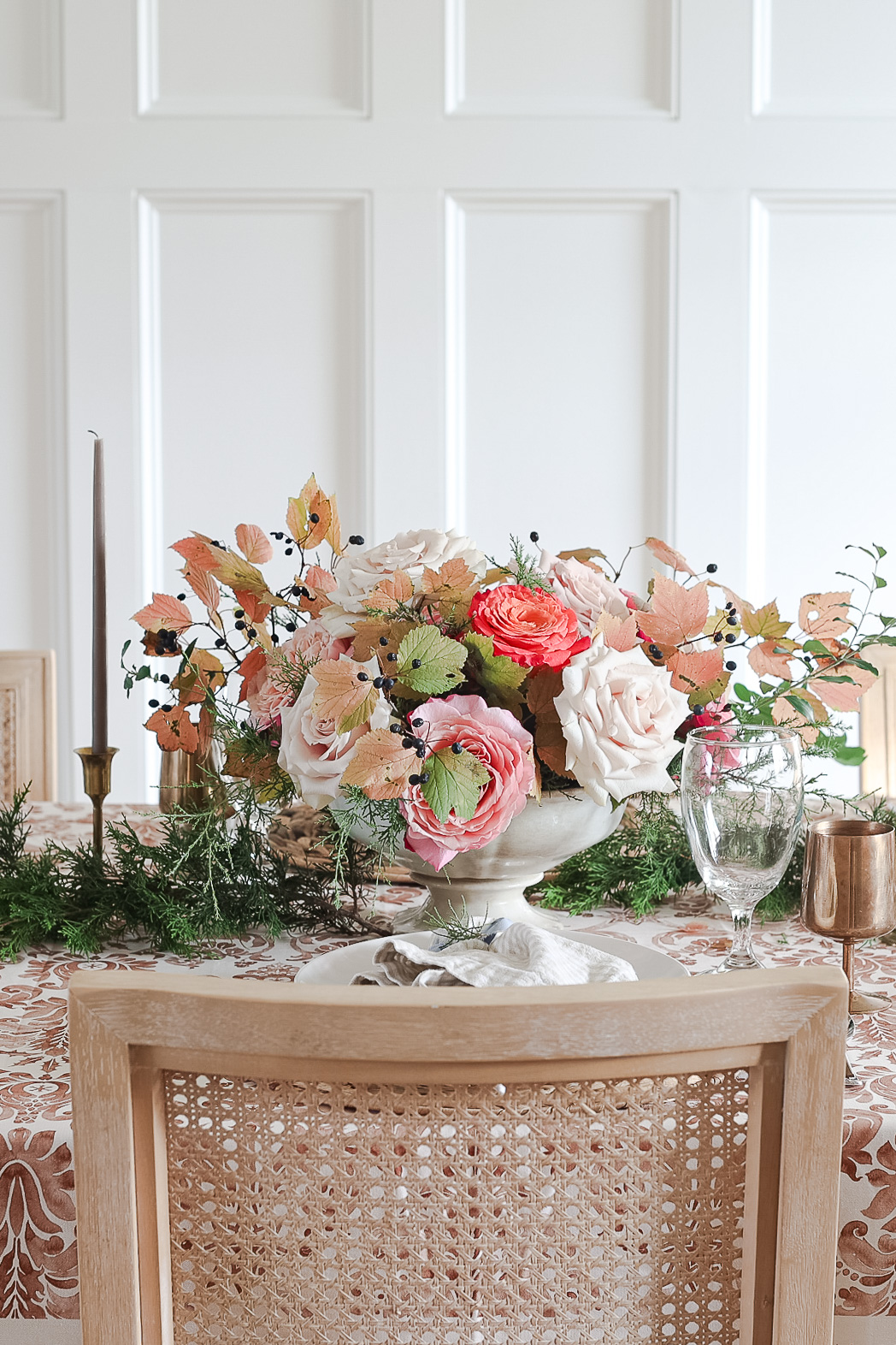 dining room table with floral centerpiece and candles