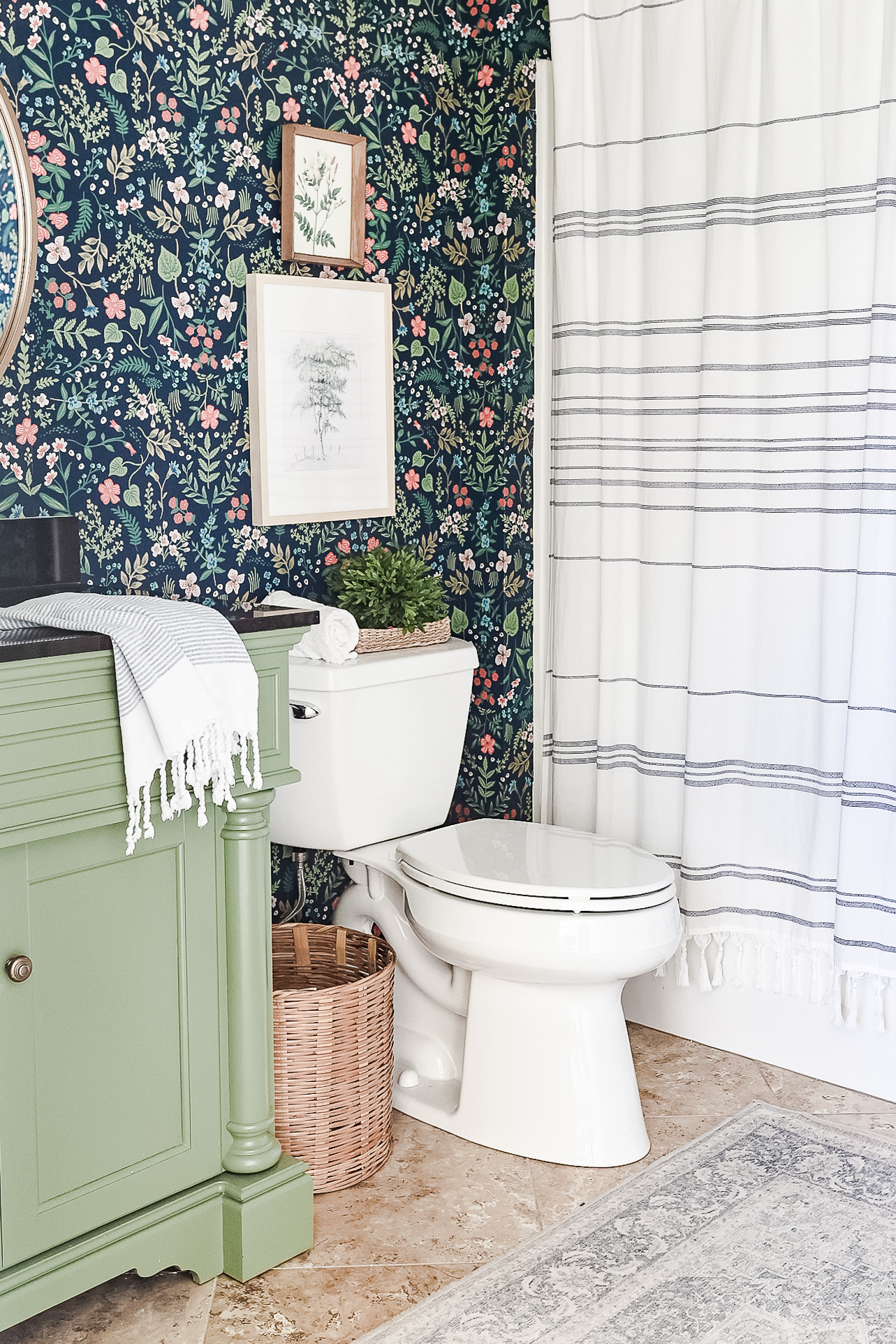 blue floral wallpaper bathroom with green vanity