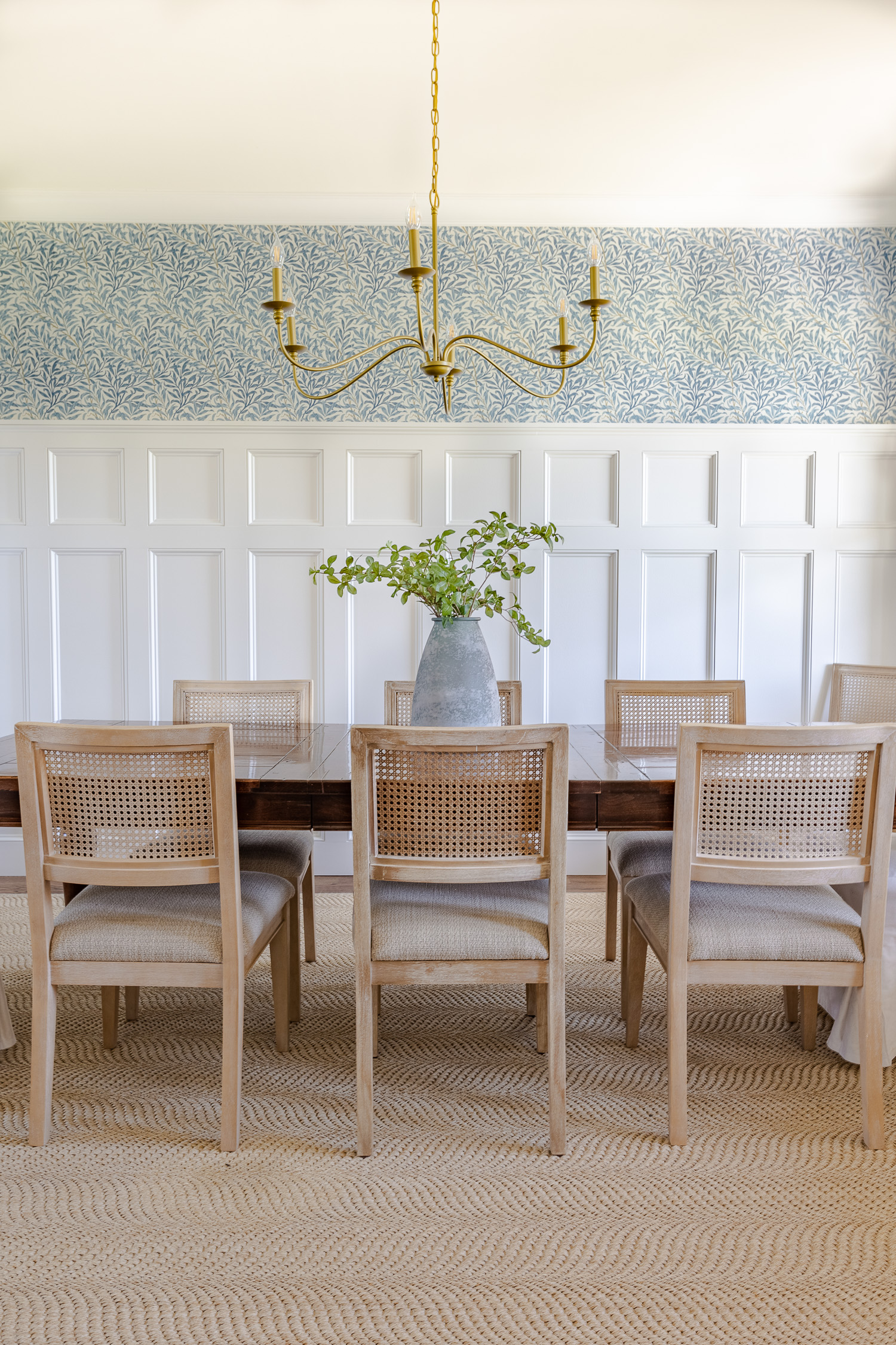 dining room with table chairs and rug and gold chandelier