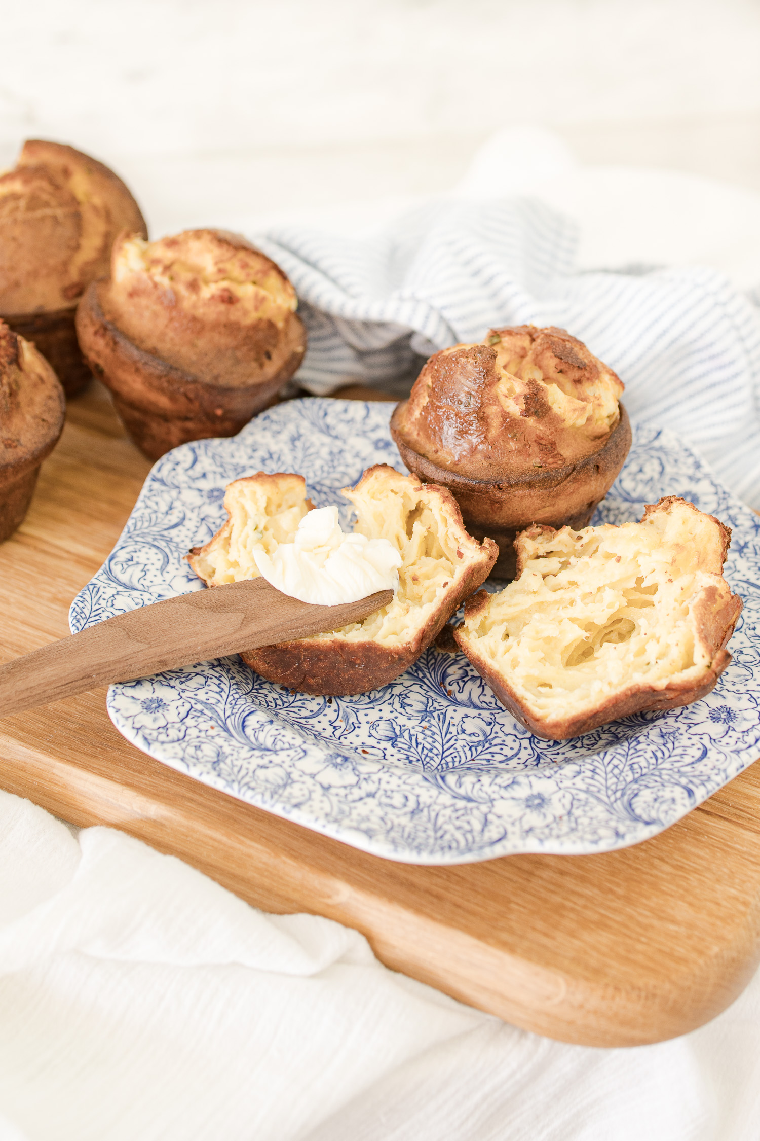popover cut open with wooden knife with butter