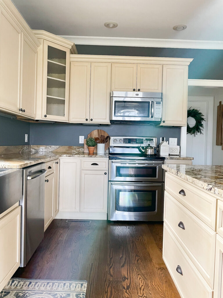 kitchen with cream cabinets, gray walls and appliances