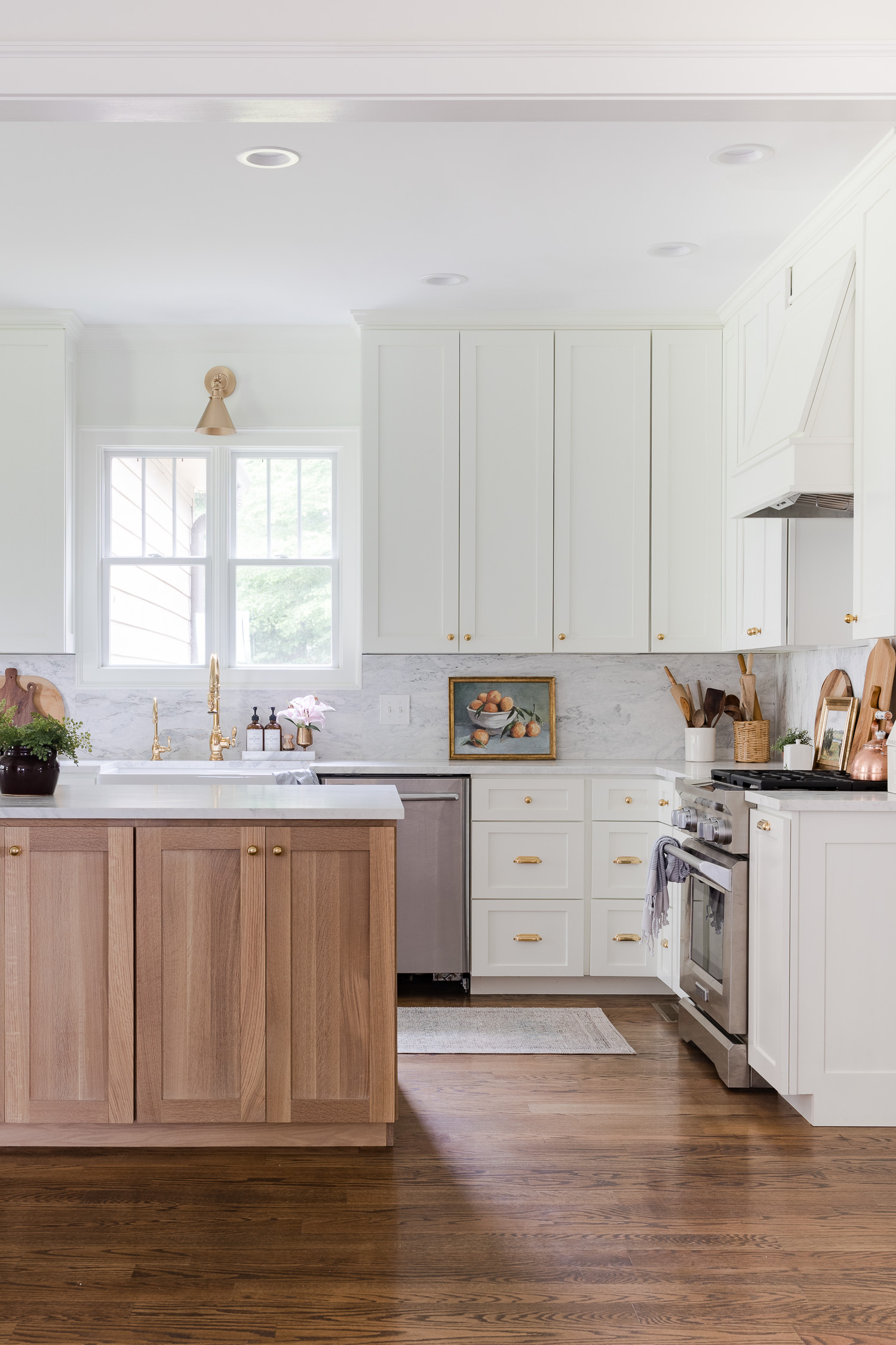 white kitchen with wood island and runner rug on the floor