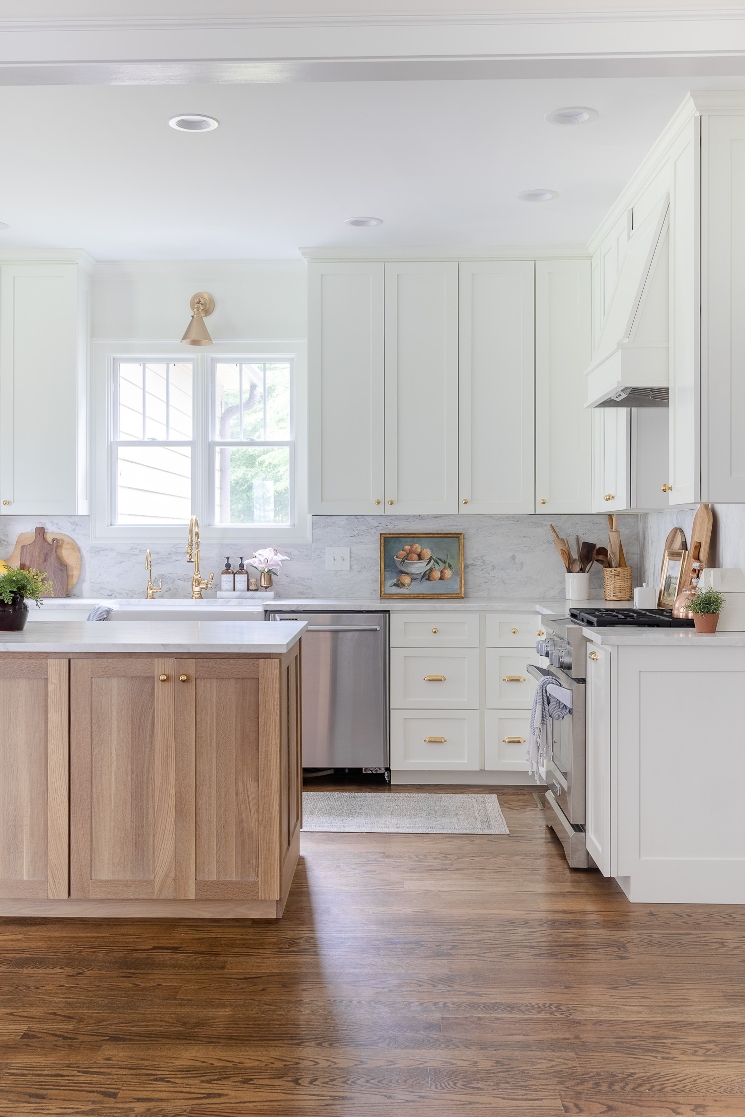 white kitchen with wood island and runner rug on the floor