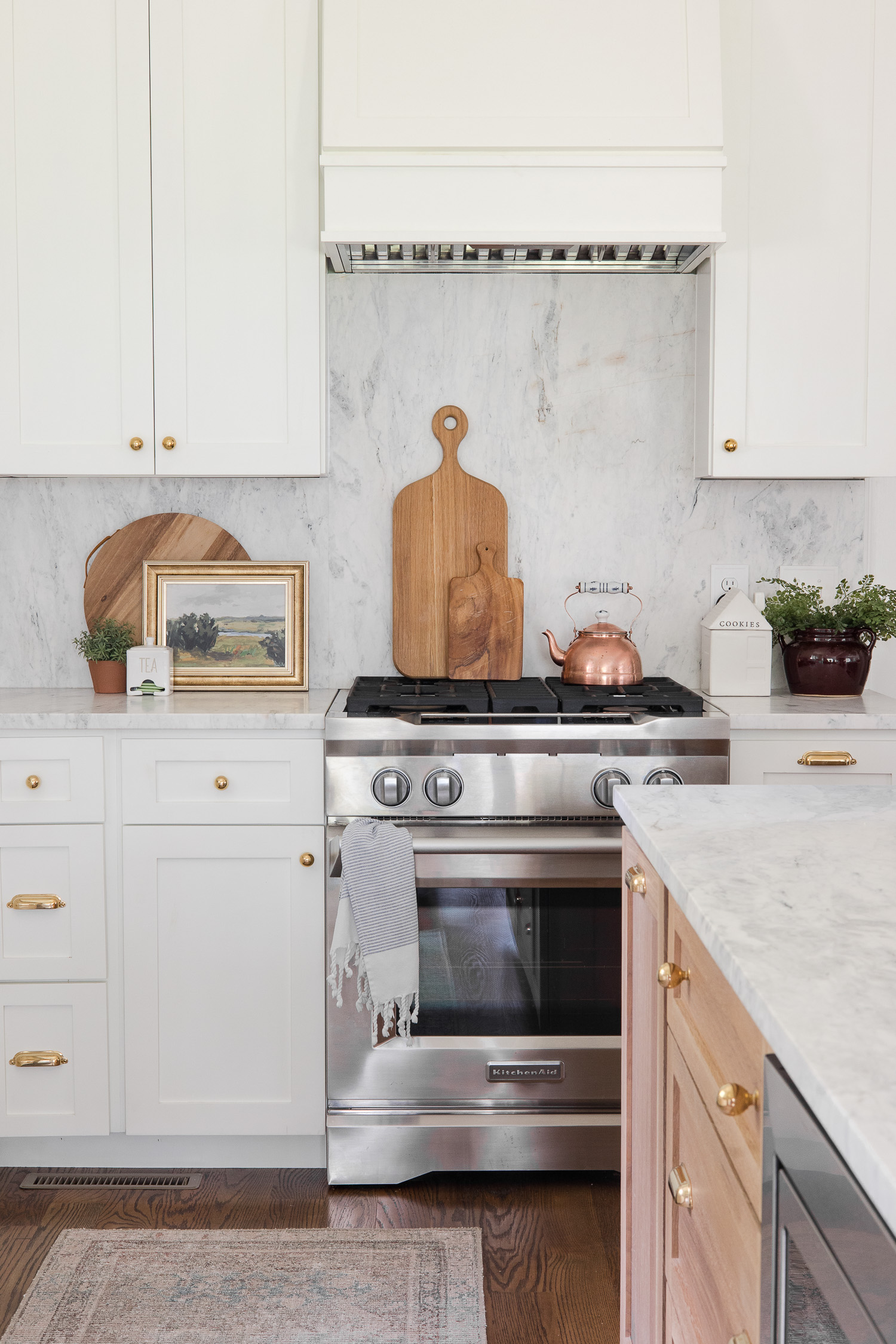white kitchen with stainless steel range
