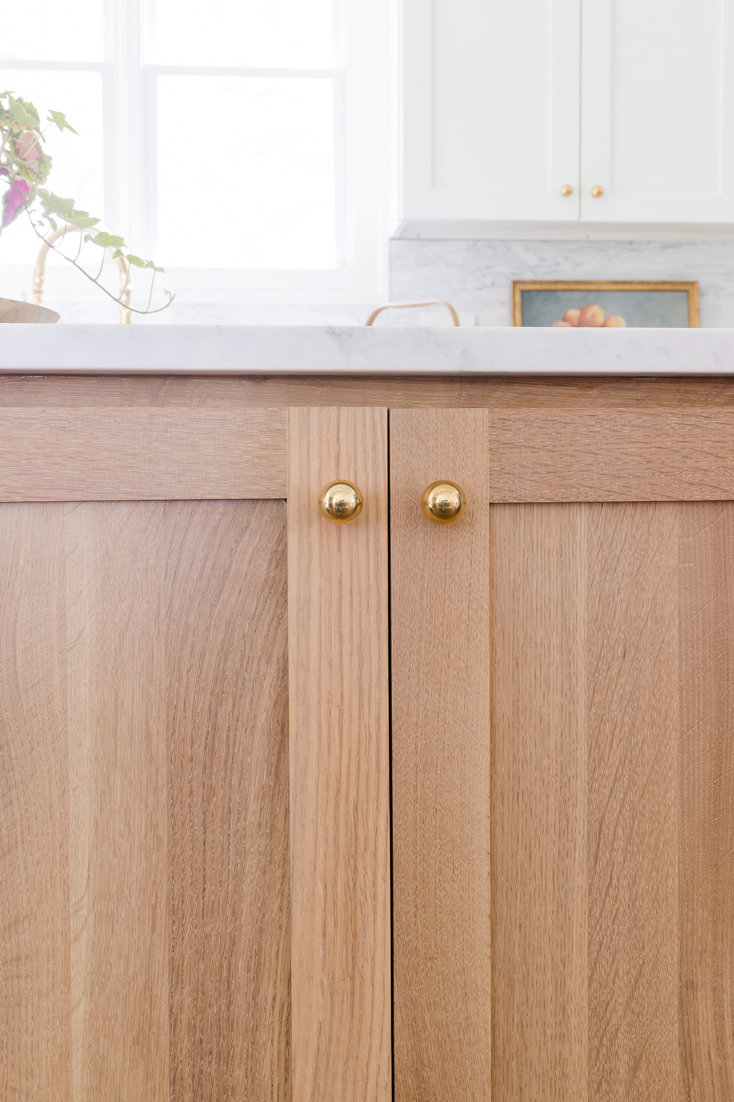 white oak cabinet with brass hardware