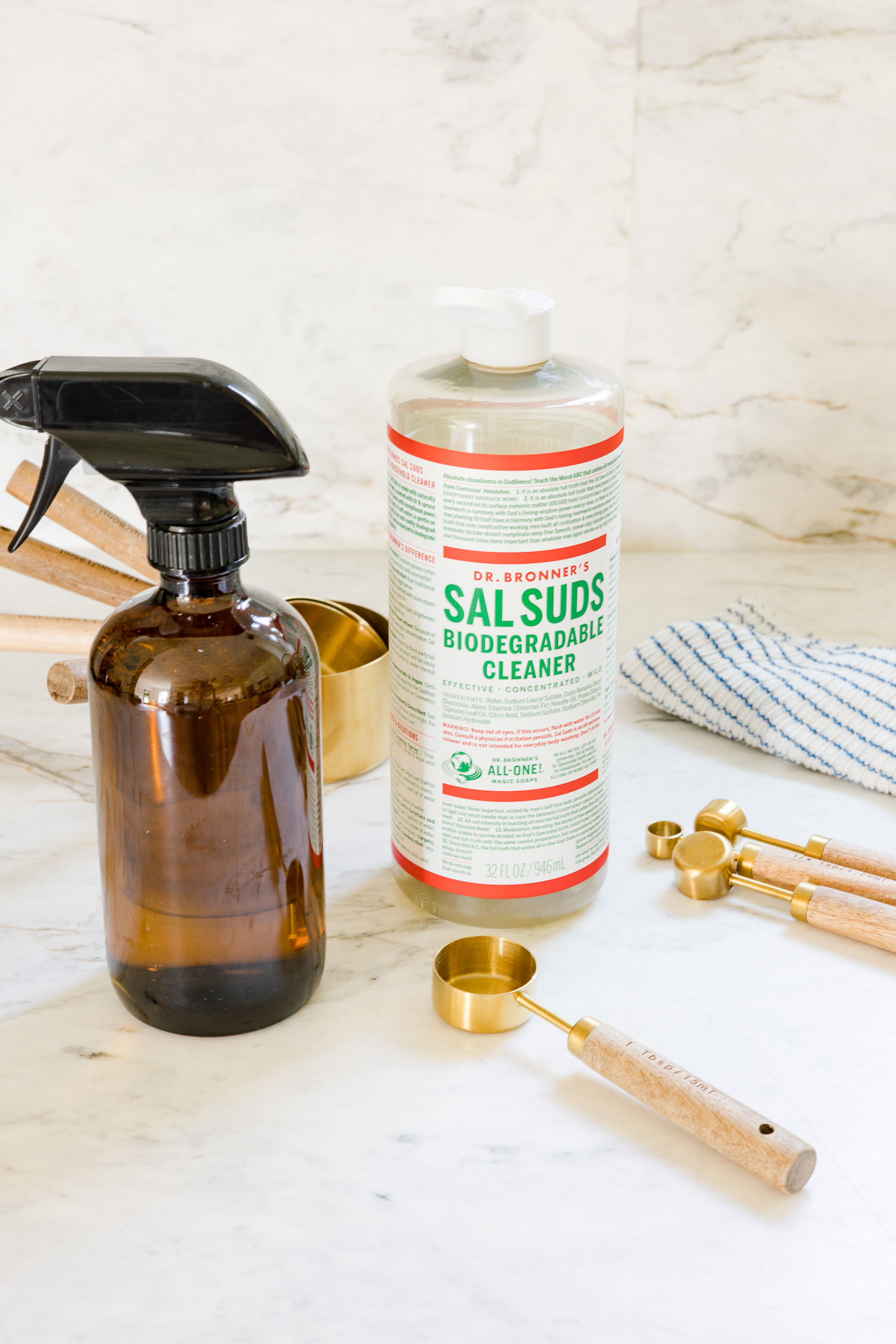 glass spray bottle and sal suds sitting on counter to make all purpose cleaner