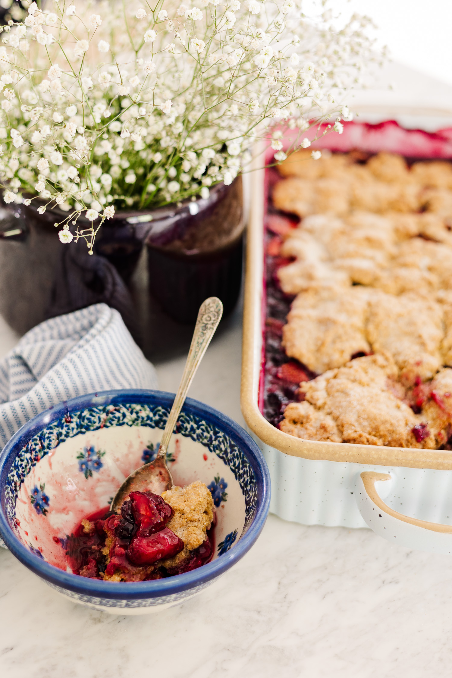 mixed Berry cobbler in casserole dish and cobbler in bowl