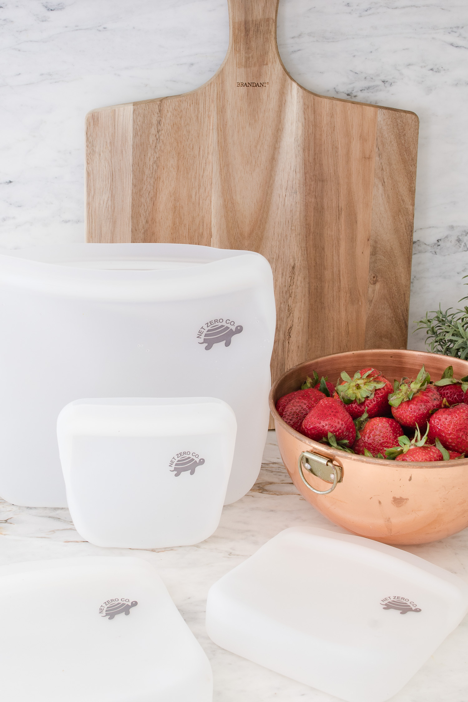 waste free living with silicone food bags on kitchen counter  with bowl of strawberries