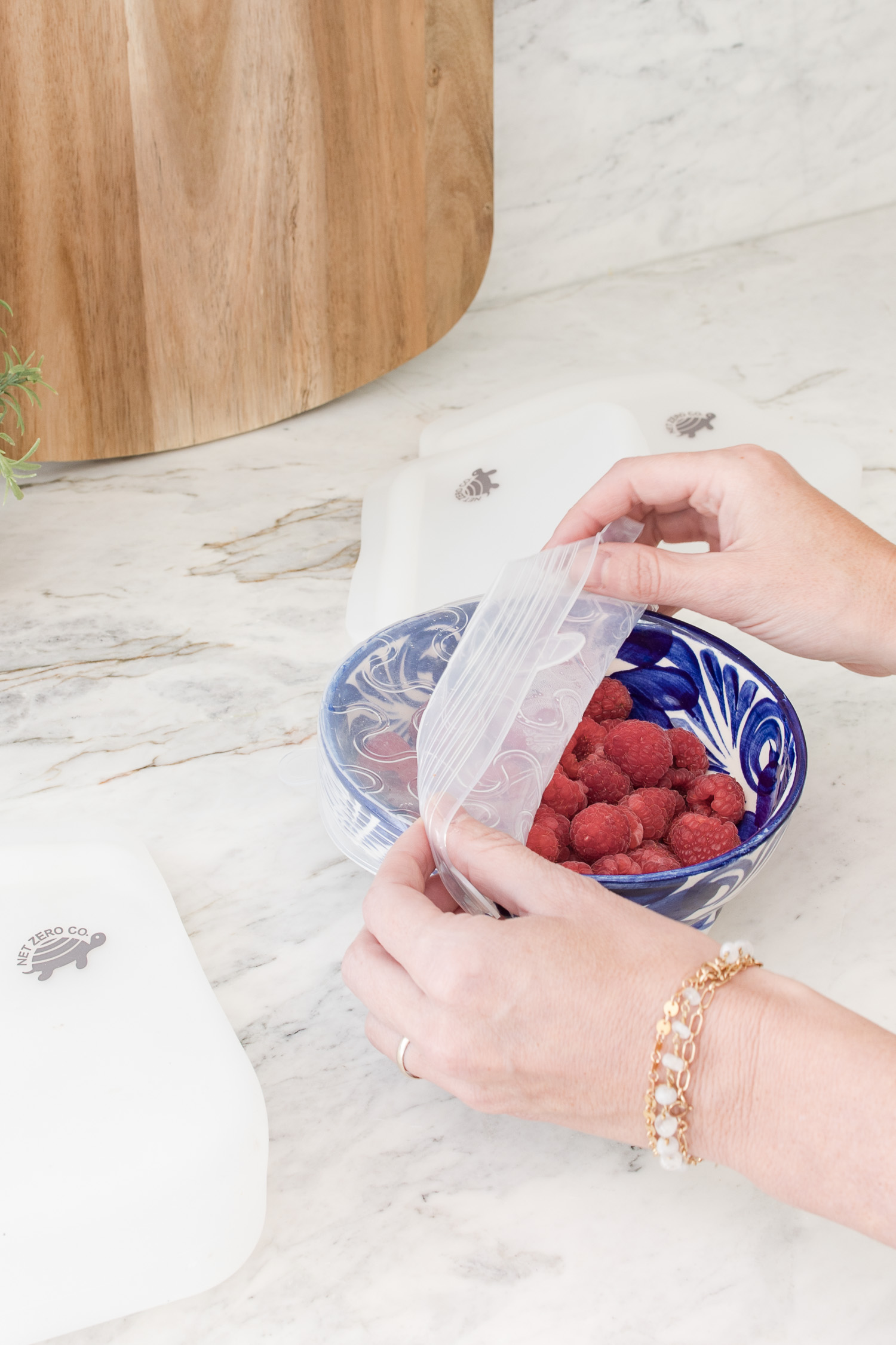jar of raspberries in kitchen with silicone cover on top
