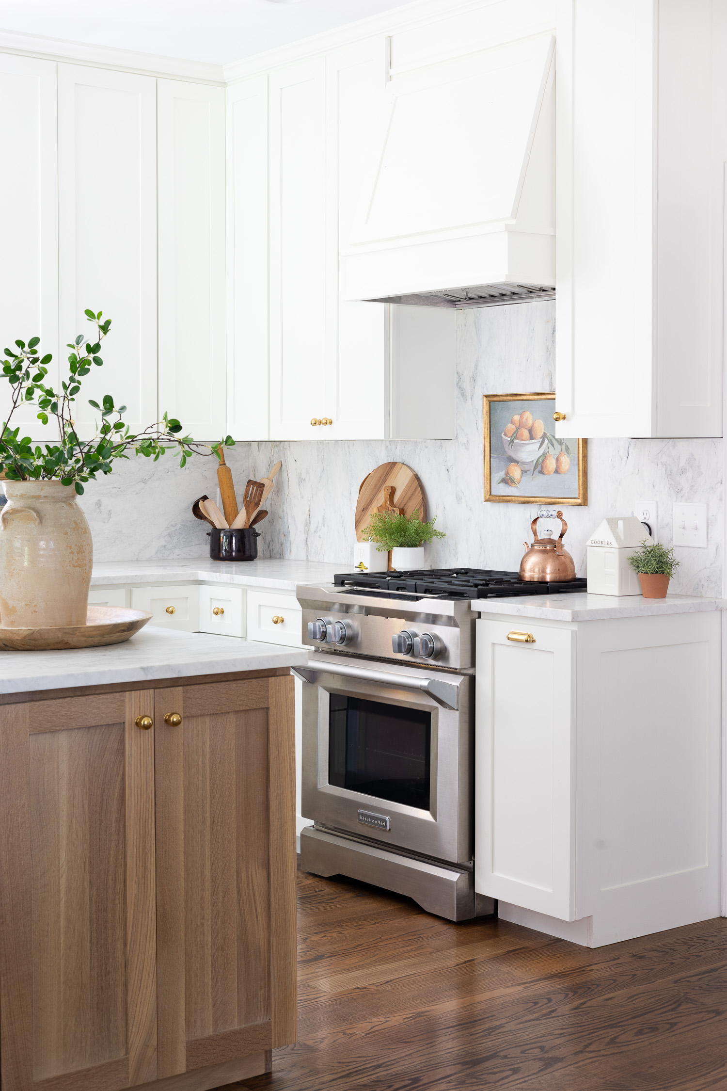 white and wood kitchen with island and marble backsplash