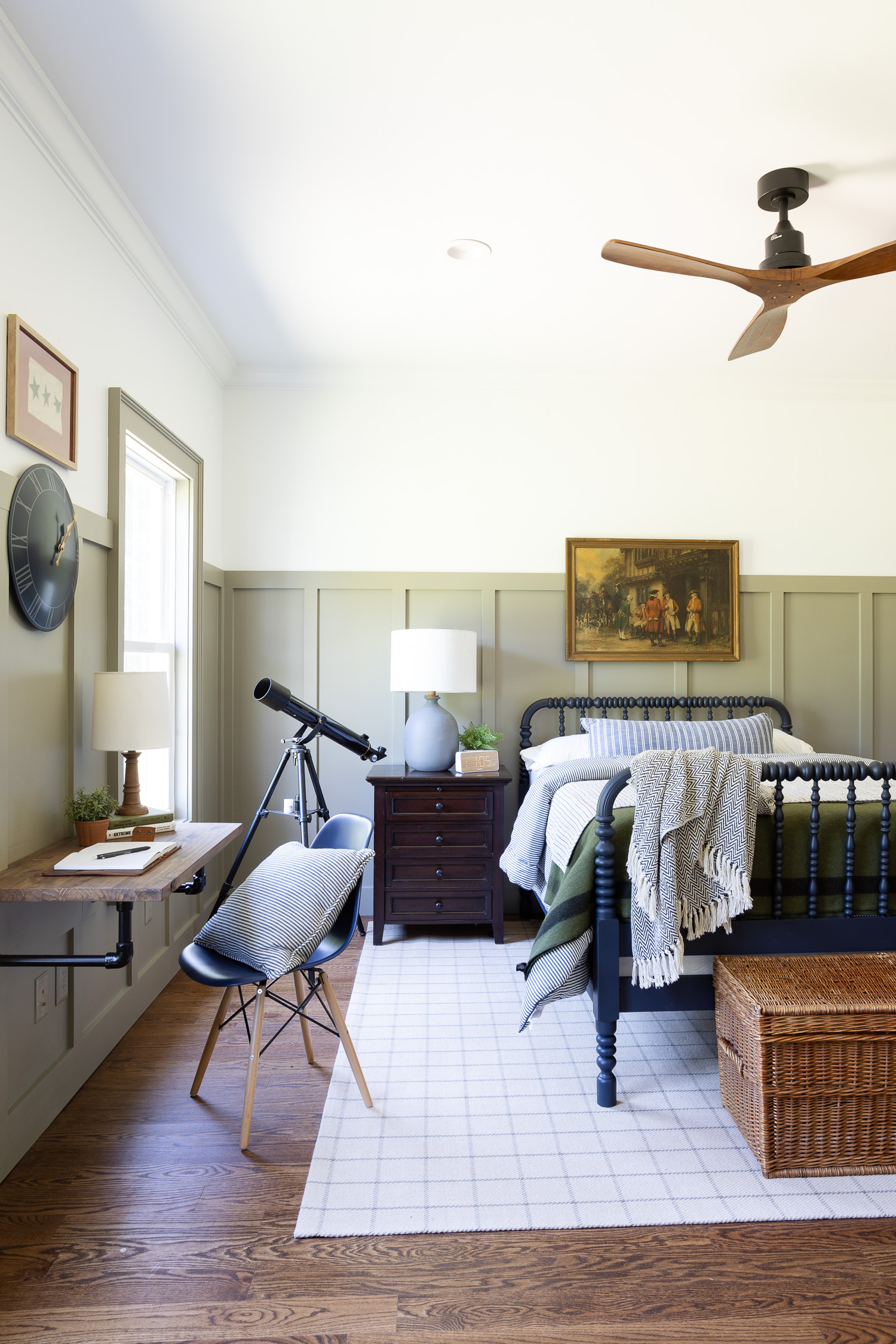 teen boy bedroom with blue spindle bed, wood fan, pipe desk and rug