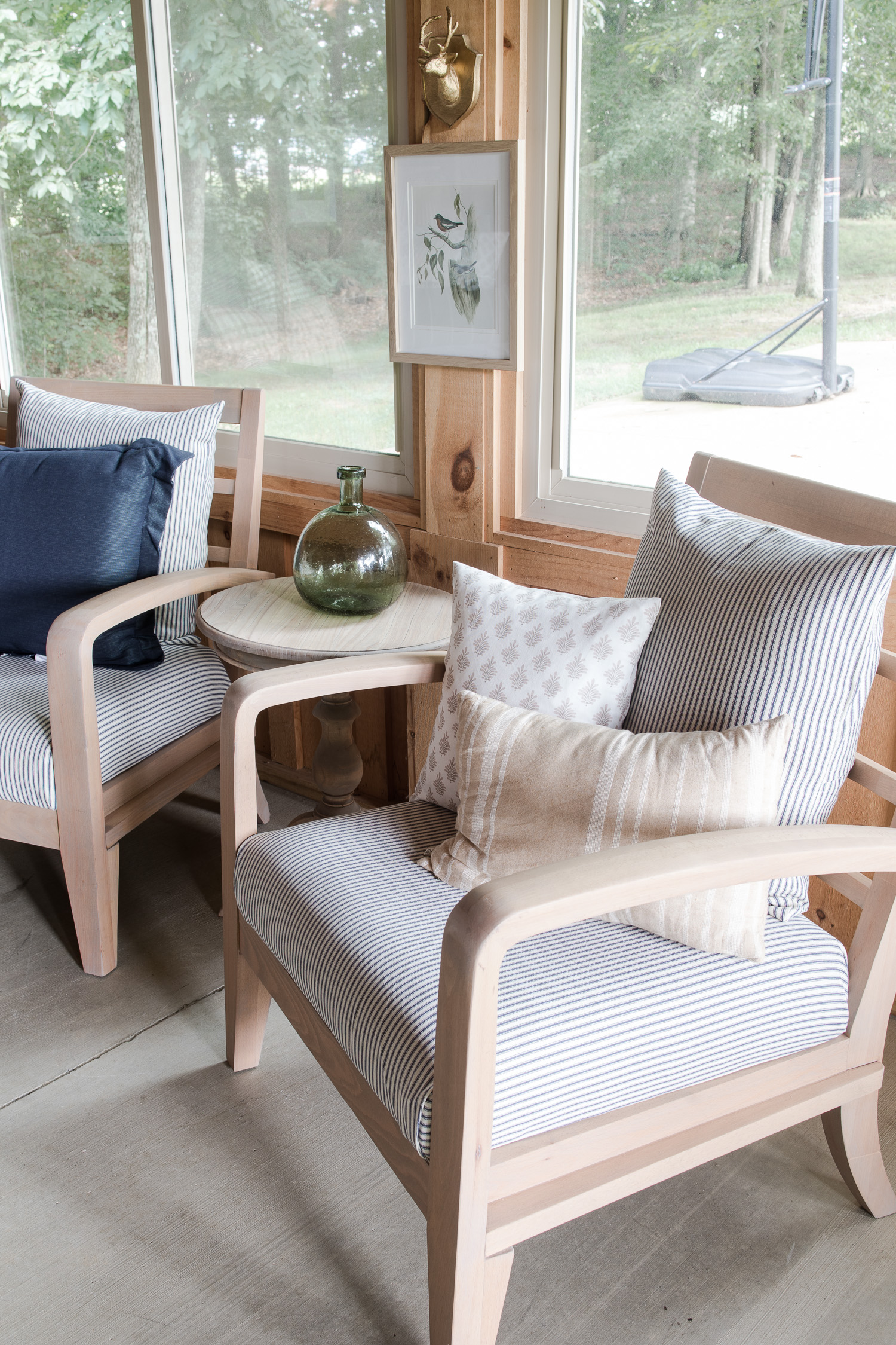 two chairs with blue and white stripe fabric in barndominium porch