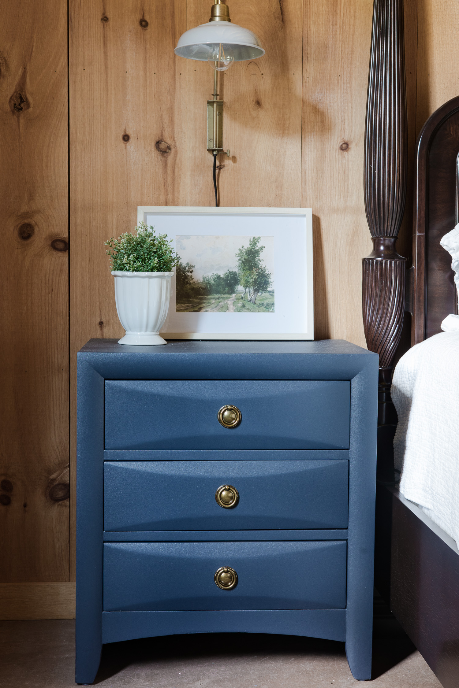 blue nightstand in log cabin bedroom