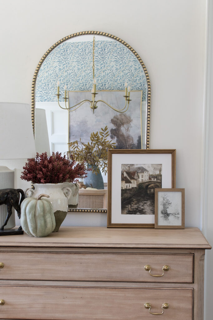 dresser with arched mirror and vintage fall art with faux stems