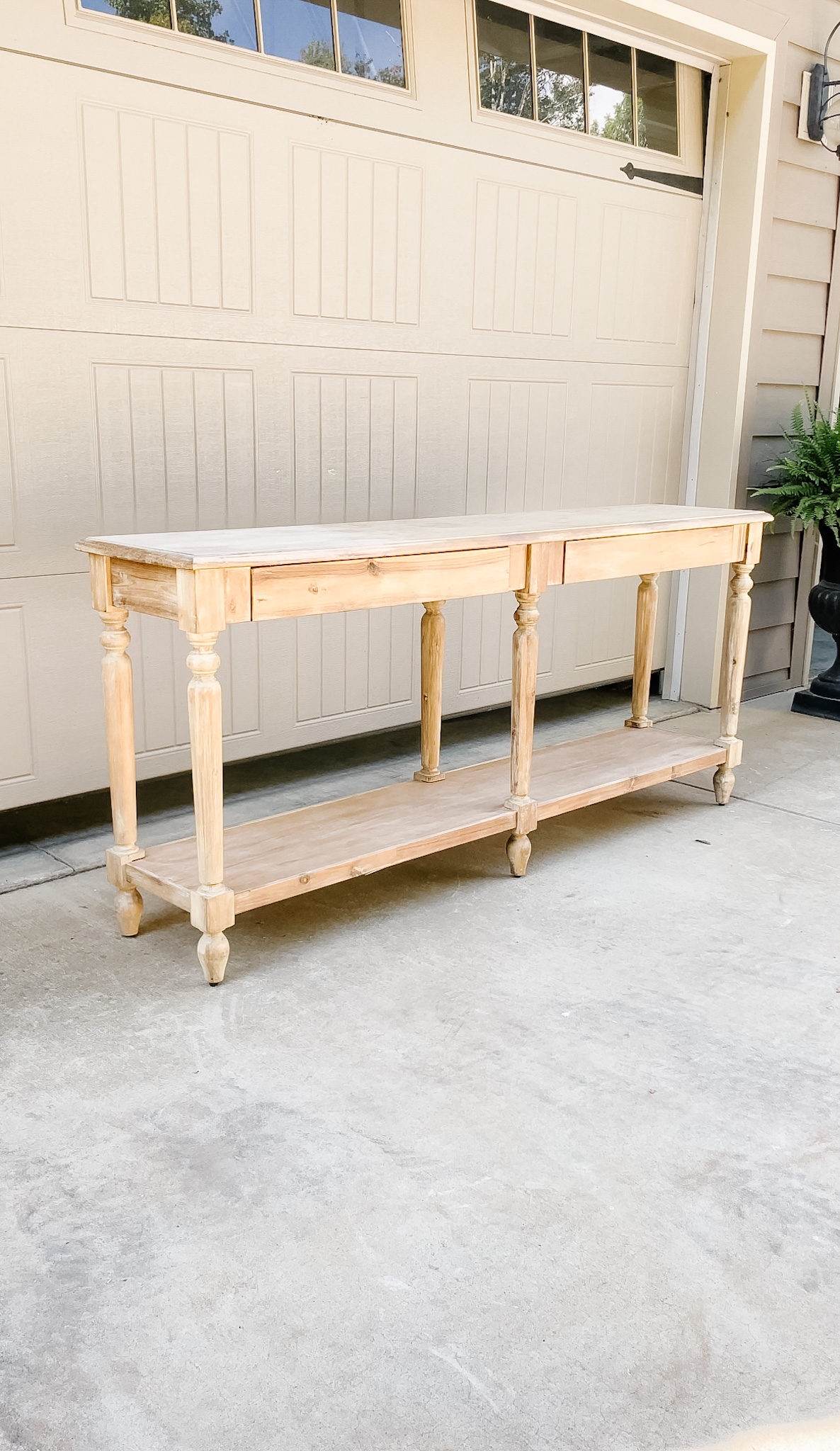 light wood console table on driveway
