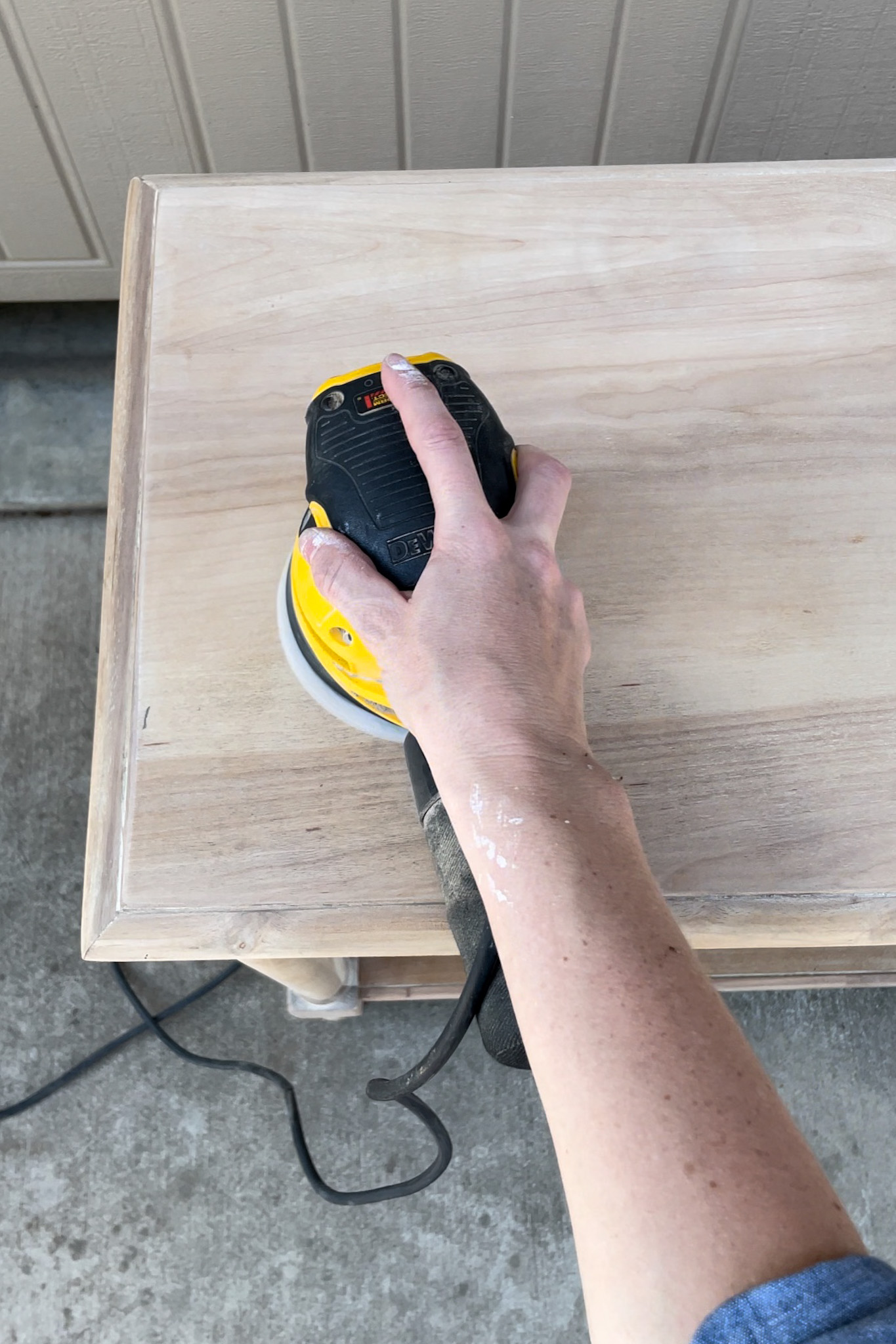 sanding wood table with sander