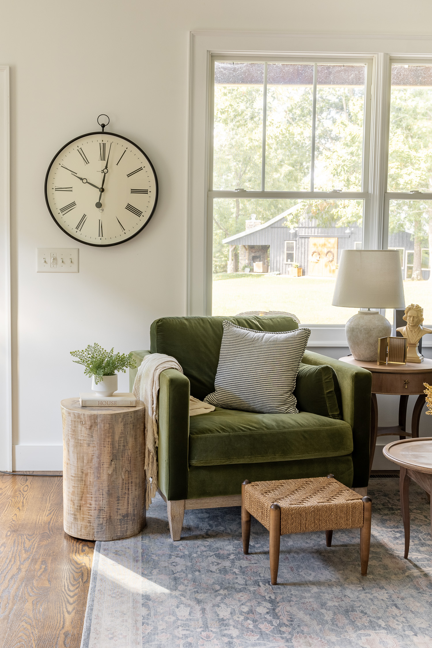 tree stump side table sitting next to green velvet chair in living room