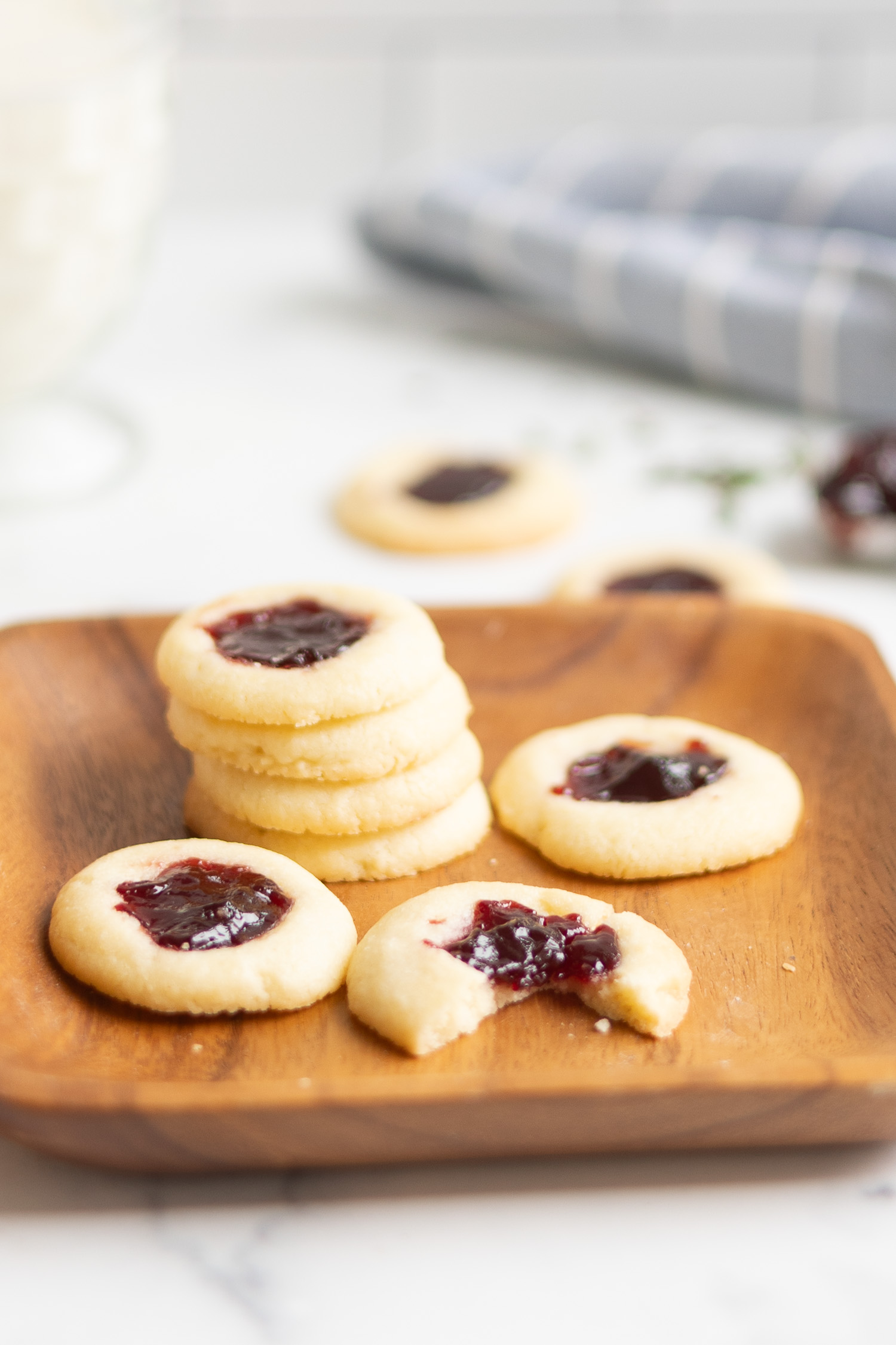 Thumbprint cookies on wood tray with glass of milk