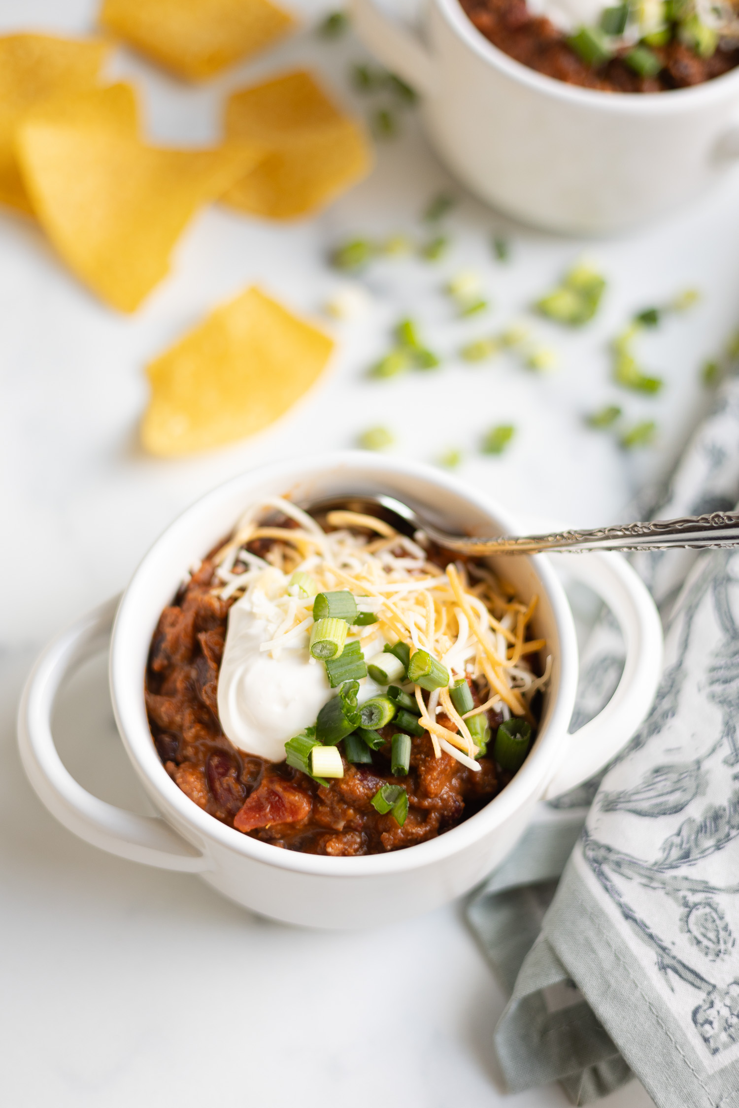 bowl of chili with tortilla chips sitting on counter