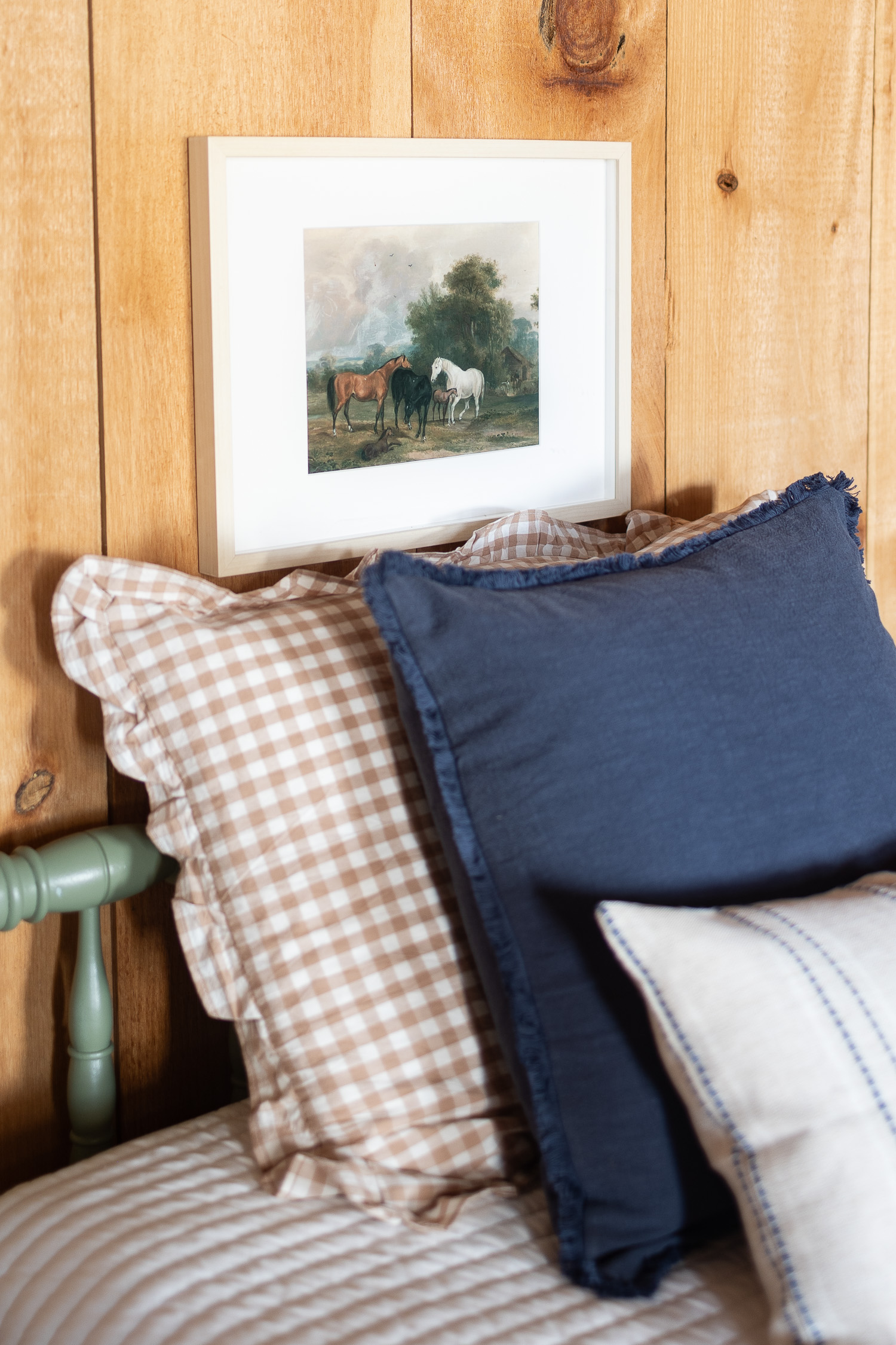 framed vintage horse print above twin bed