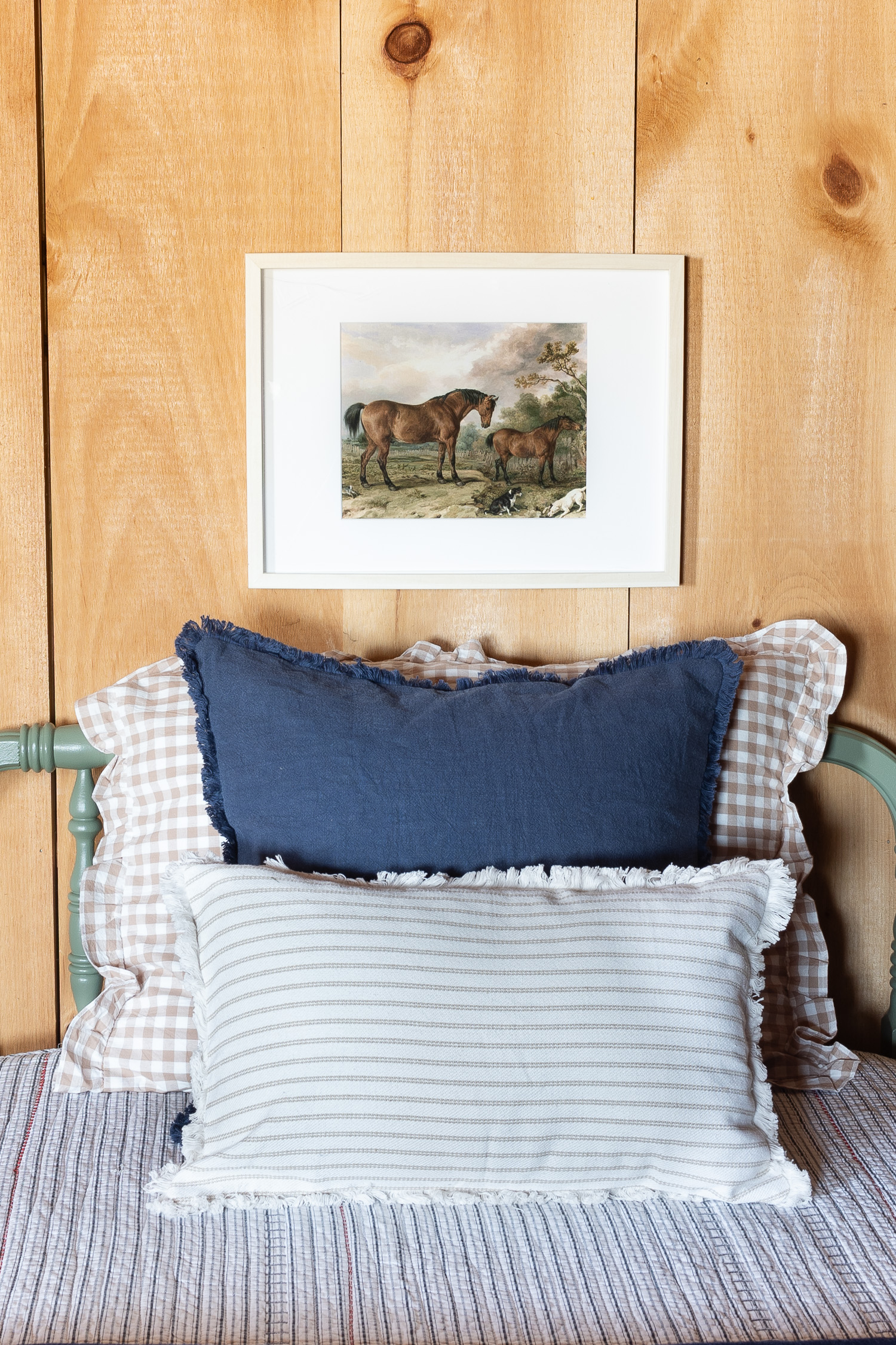 vintage horse print framed and hanging above bed
