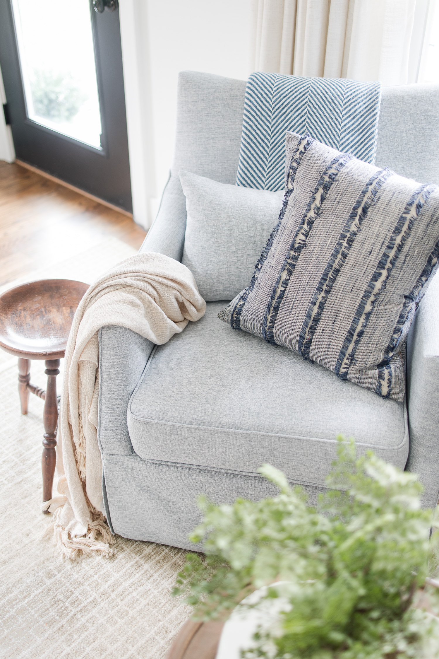 blue stripe pillow in blue swivel chair