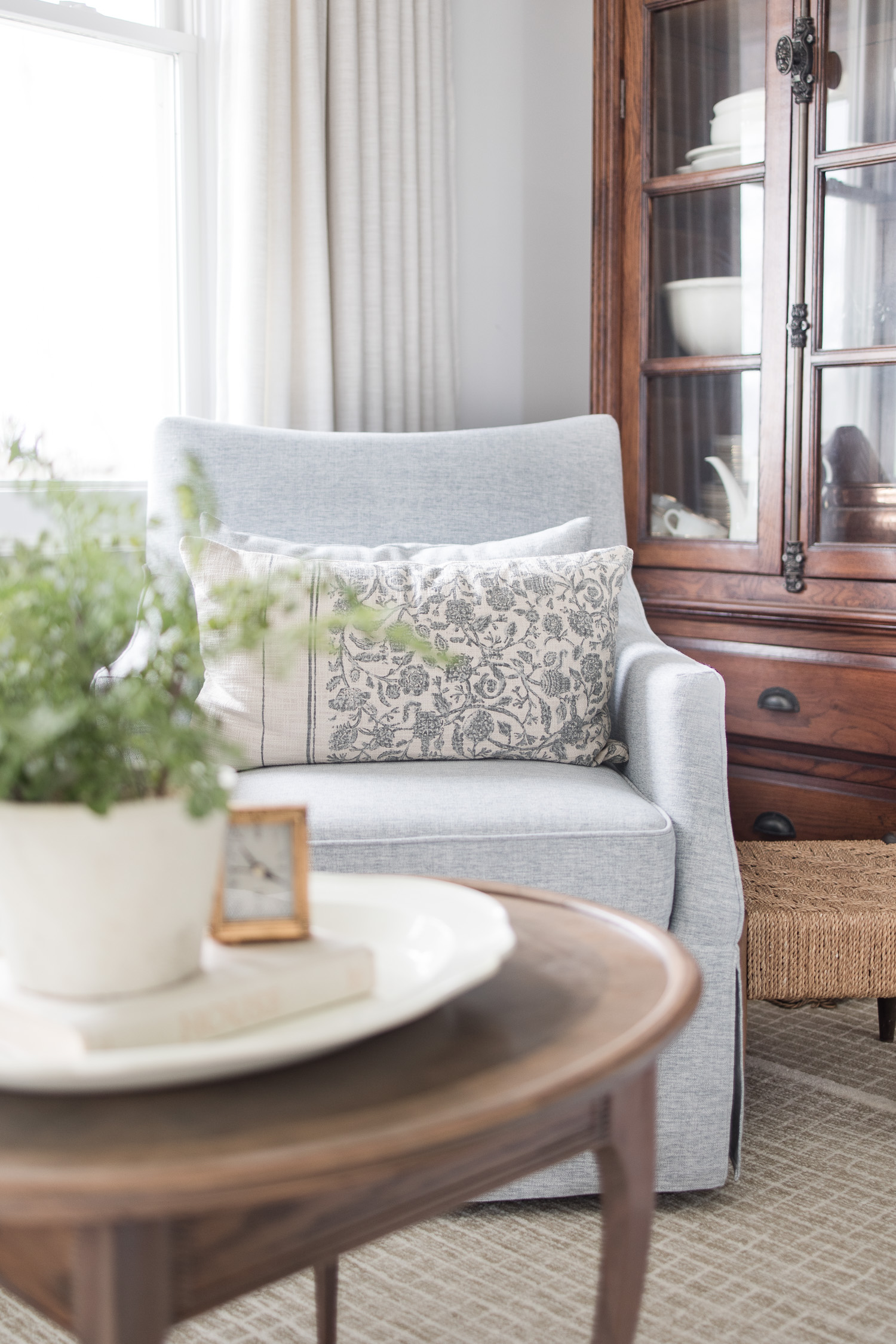 blue and white floral pillow on blue chair