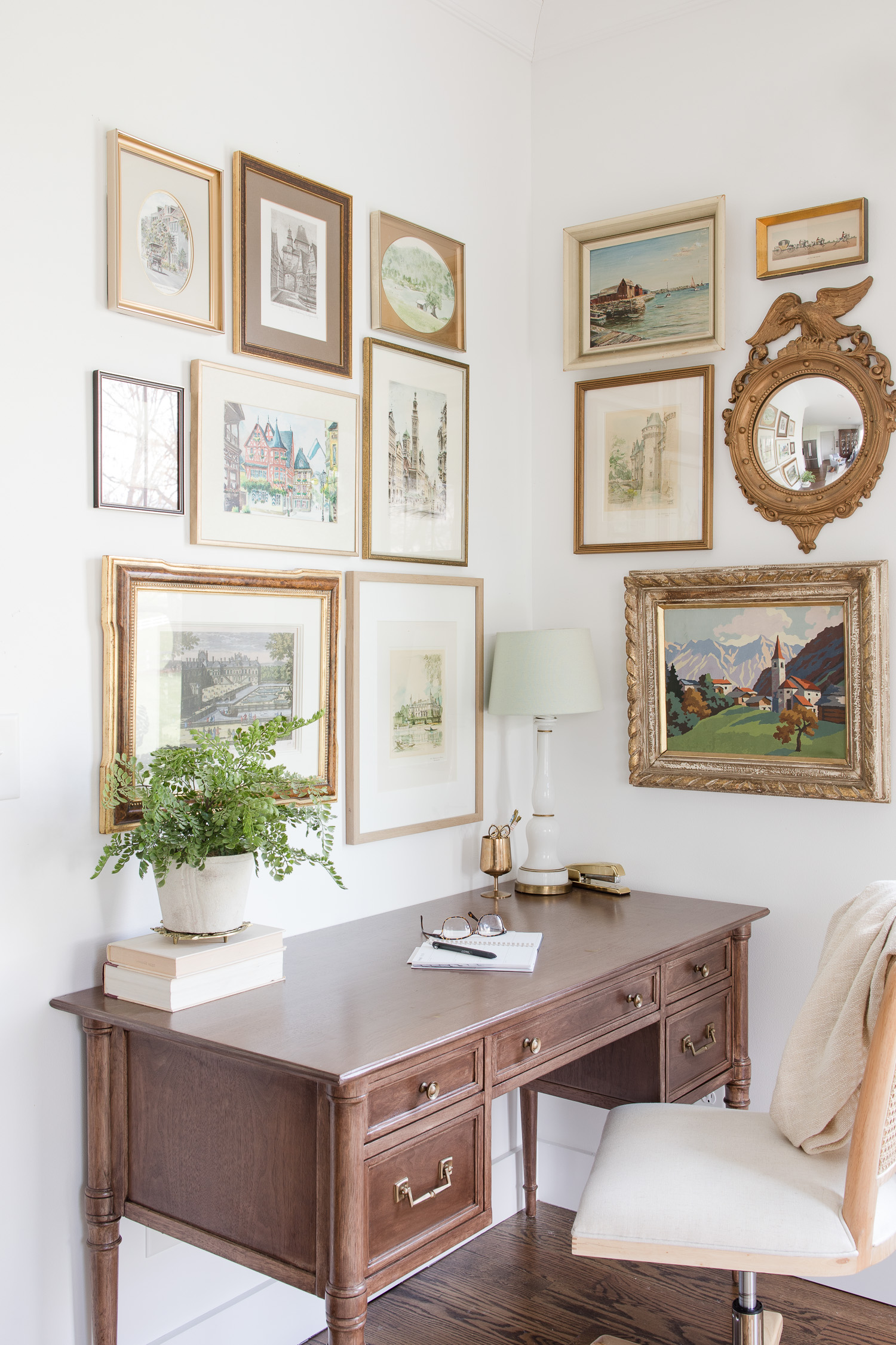 small home office with gallery wall above desk