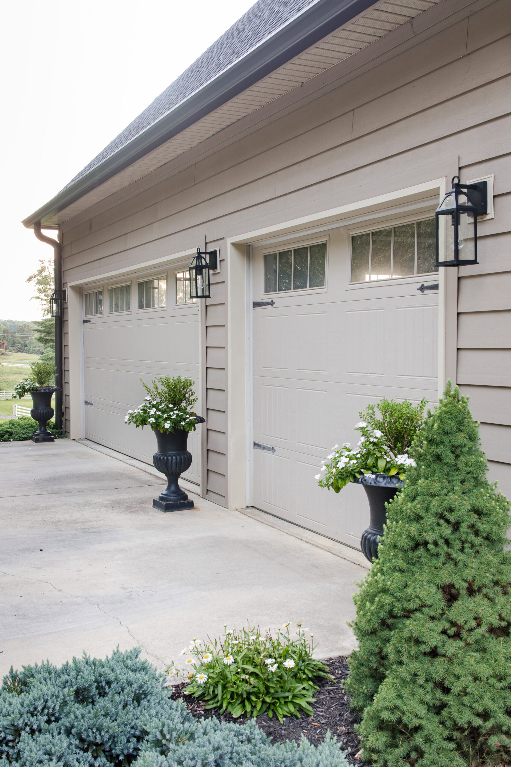 outdoor light fixtures outside of garage doors on driveway