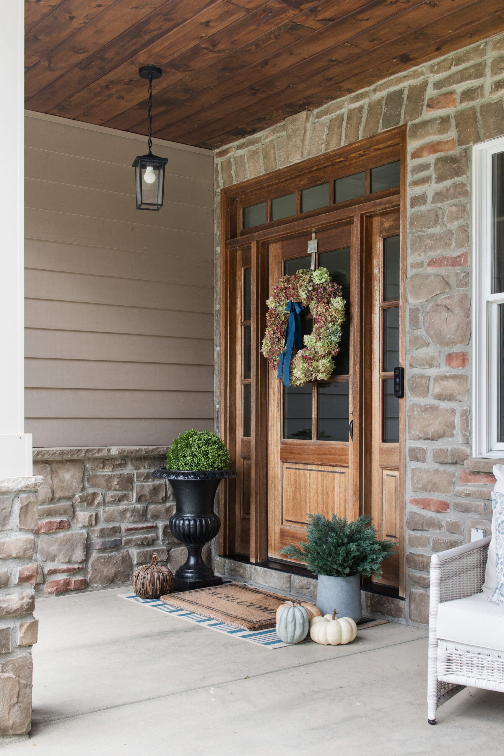 front patio with wood door and hydrangea wreath