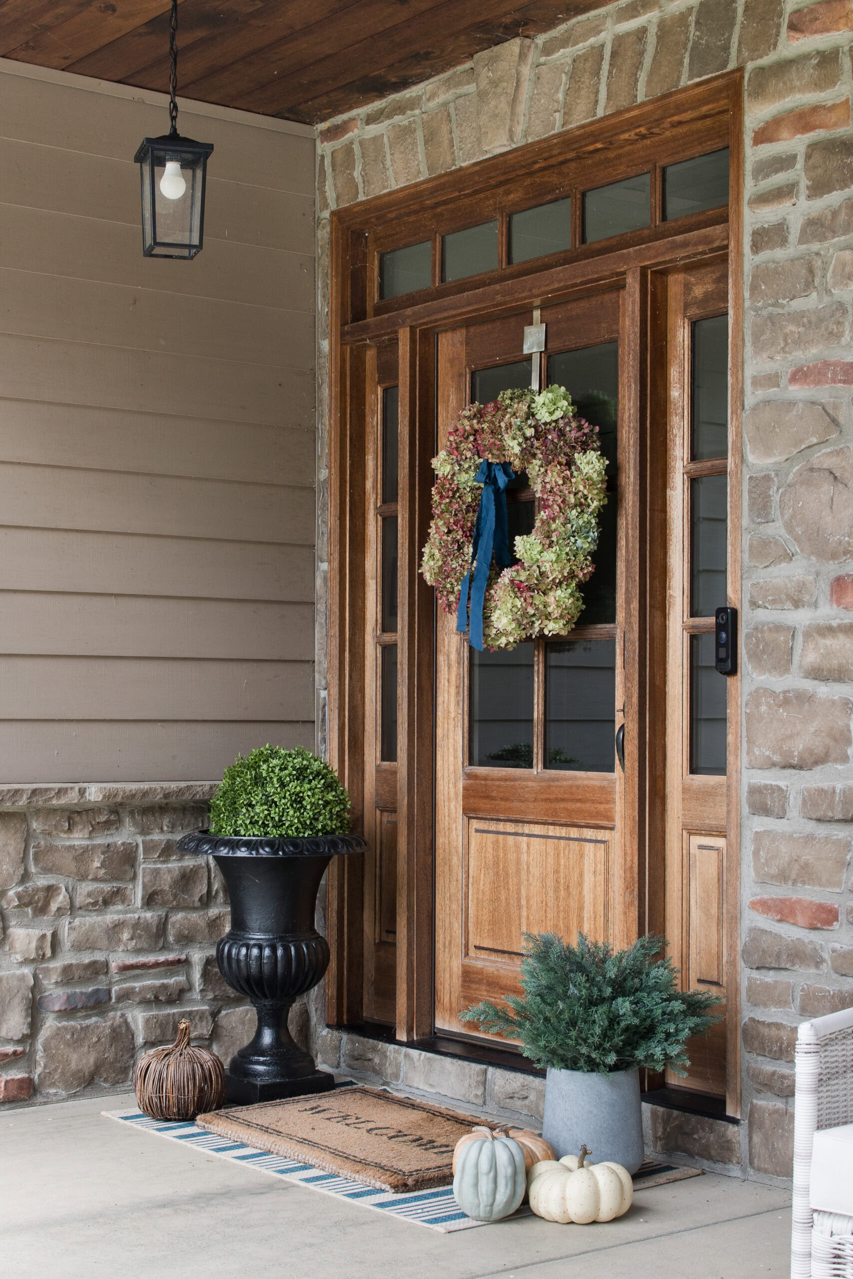 front patio with wood door and hydrangea wreath