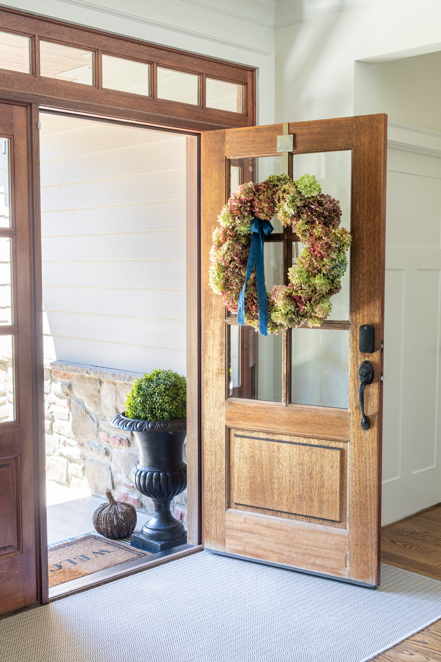 hydrangea wreath at front door with neutral fall decor