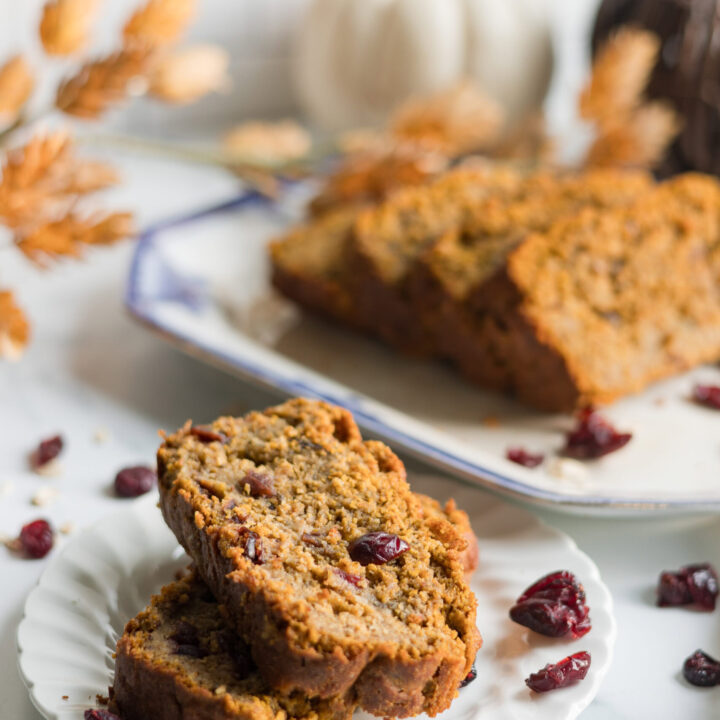 plate of pumpkin cranberry banana bread