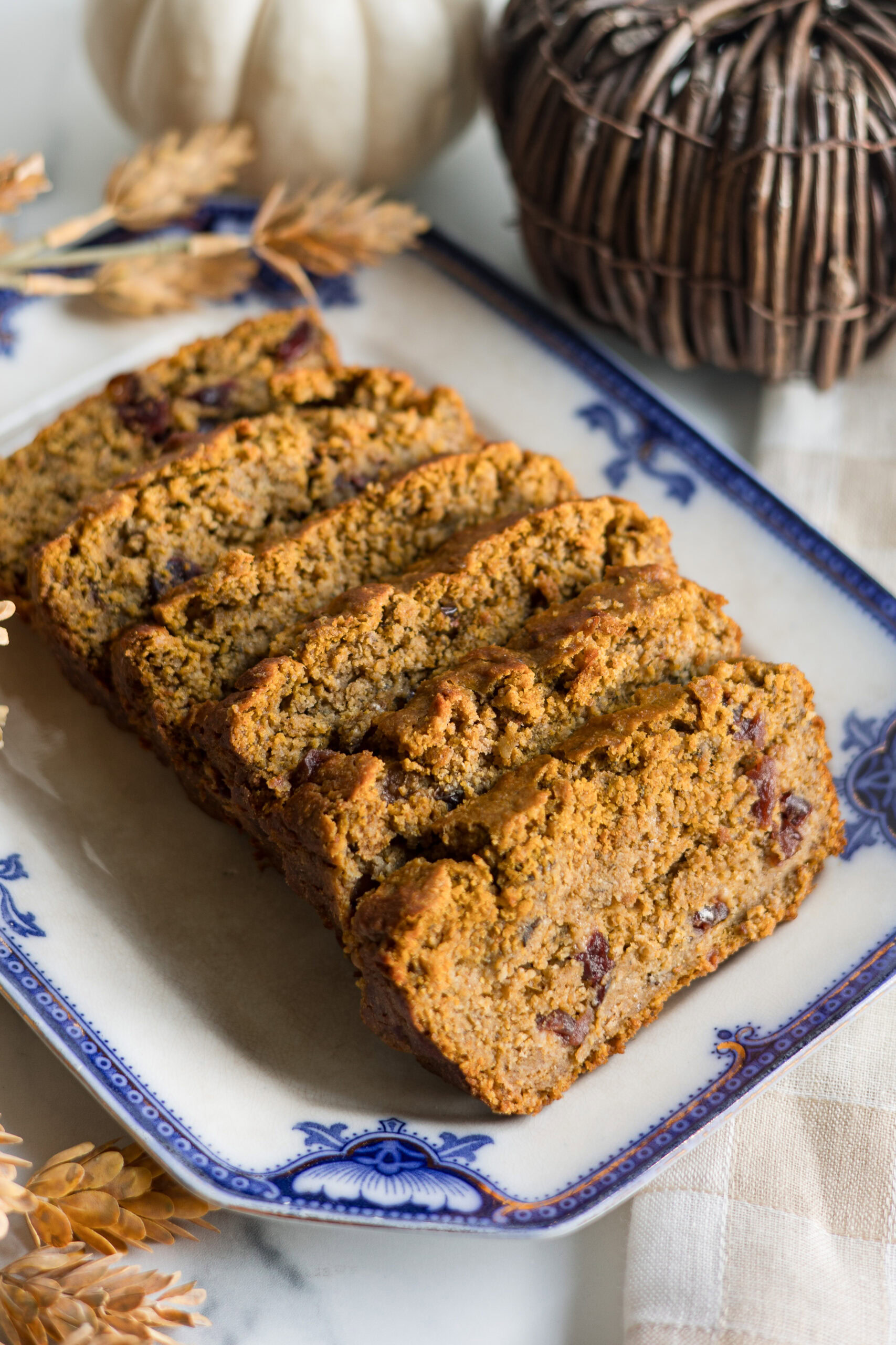 sliced pumpkin cranberry bread on a platter